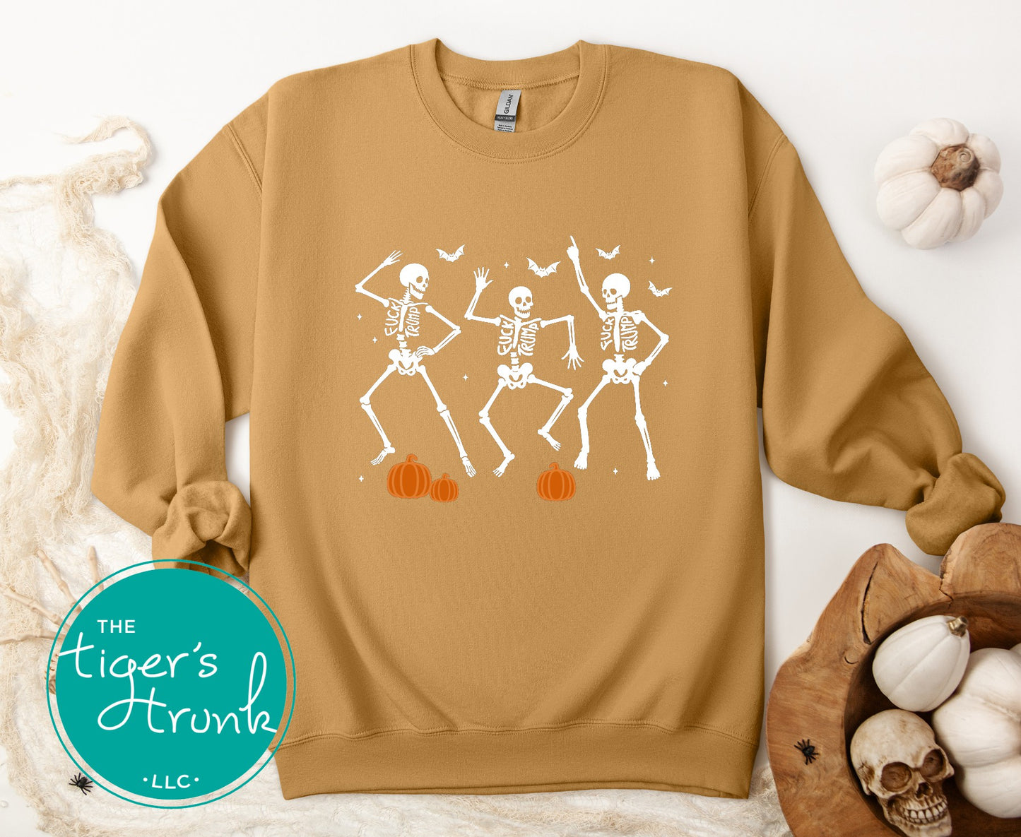 Brown sweatshirt with skeleton design on a white background, featuring 'The Tiger's Trunk' logo.