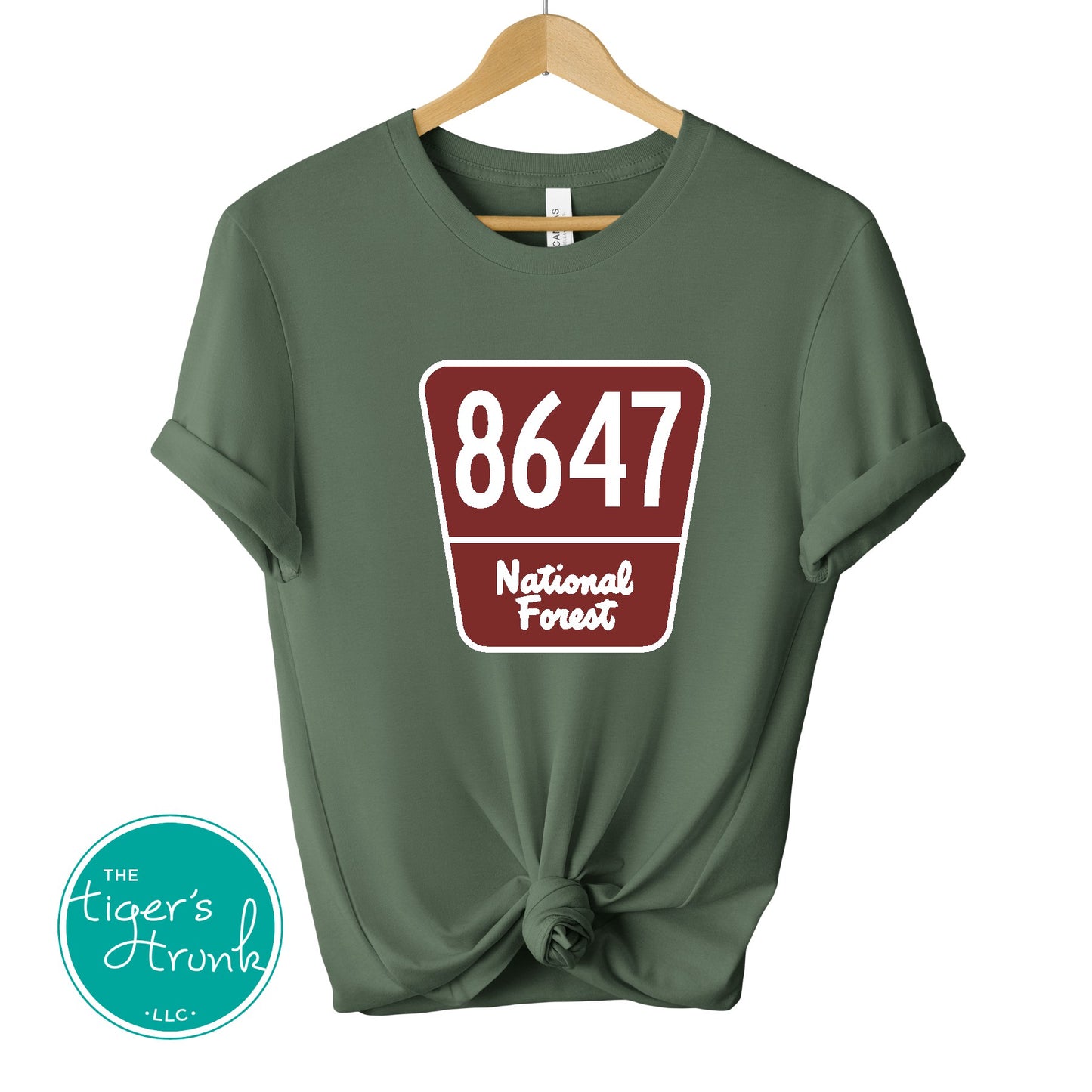T-shirt with 8647 on a National Forest-style sign, earthy and subtle political protest design for nature lovers