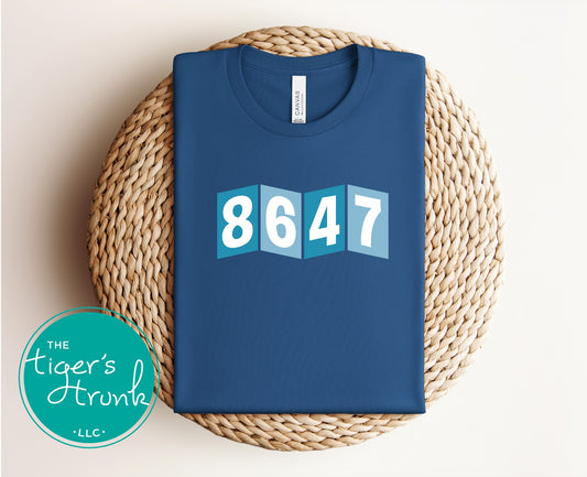 Close-up of a shirt featuring the number 8647, a subtle nod to resistance and activism.