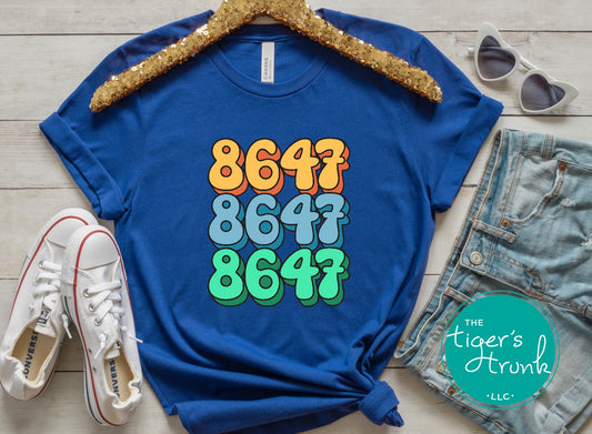 Close-up of a shirt featuring the number 8647, a subtle nod to resistance and activism.