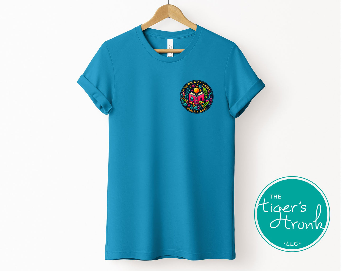 T-shirt with the phrase "A Book a Day Keeps Reality Away," perfect for readers, book lovers, and introverts