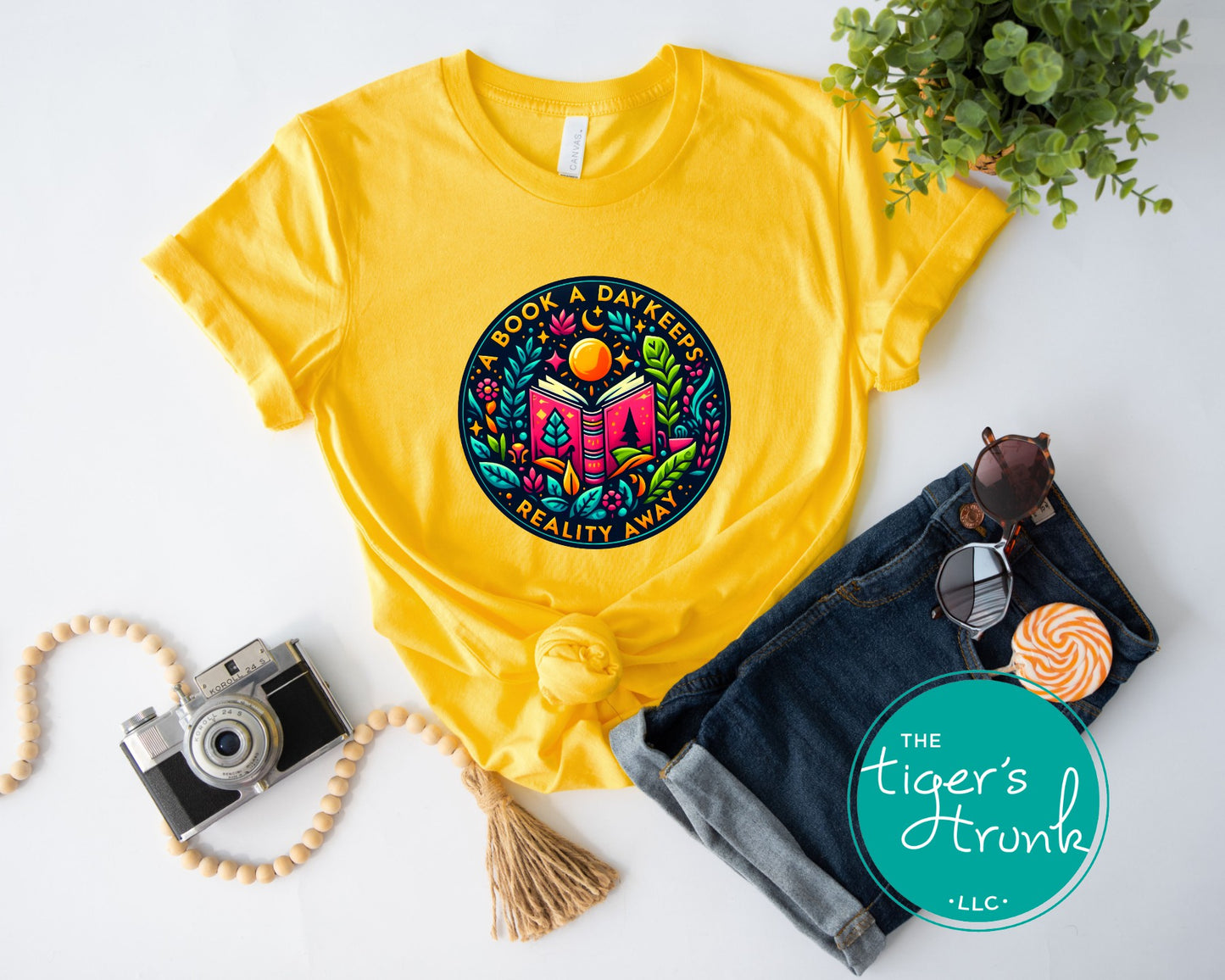 T-shirt with the phrase "A Book a Day Keeps Reality Away," perfect for readers, book lovers, and introverts