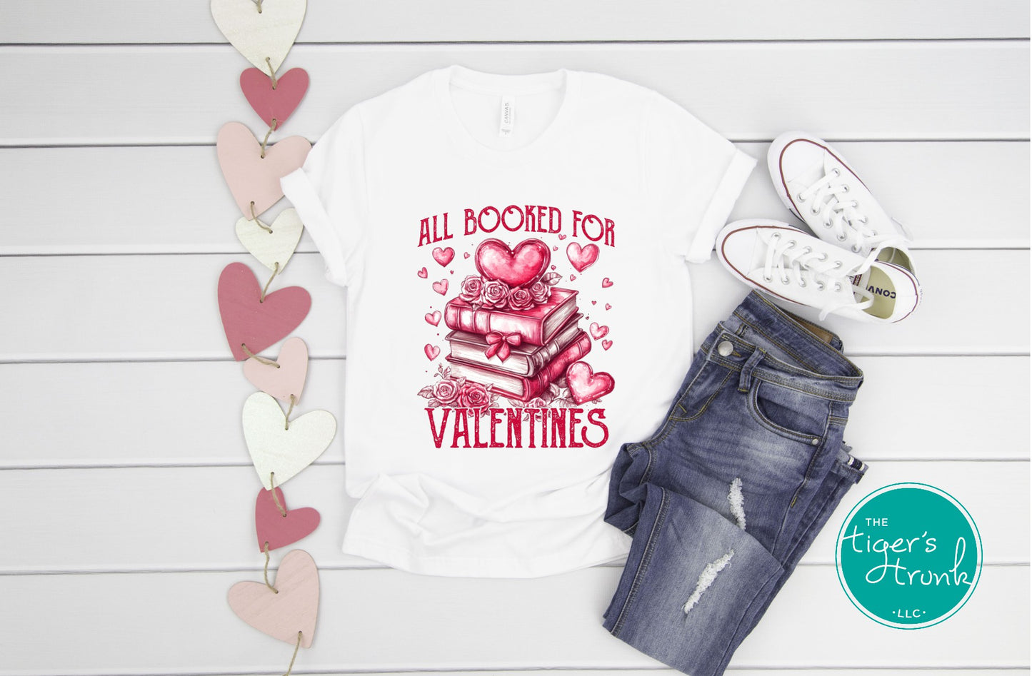 Shirt with stacked books, hearts, and roses, featuring the phrase "All Booked for Valentine’s." Perfect for book lovers.