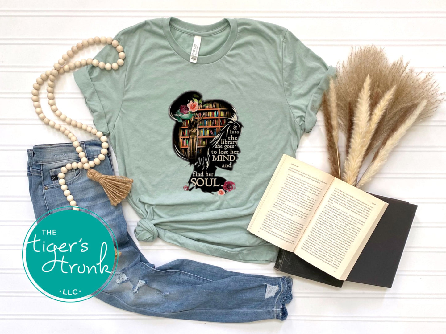 T-shirt with the quote "And to the Library She Goes to Lose Her Mind and Find Her Soul," perfect for readers and book lovers