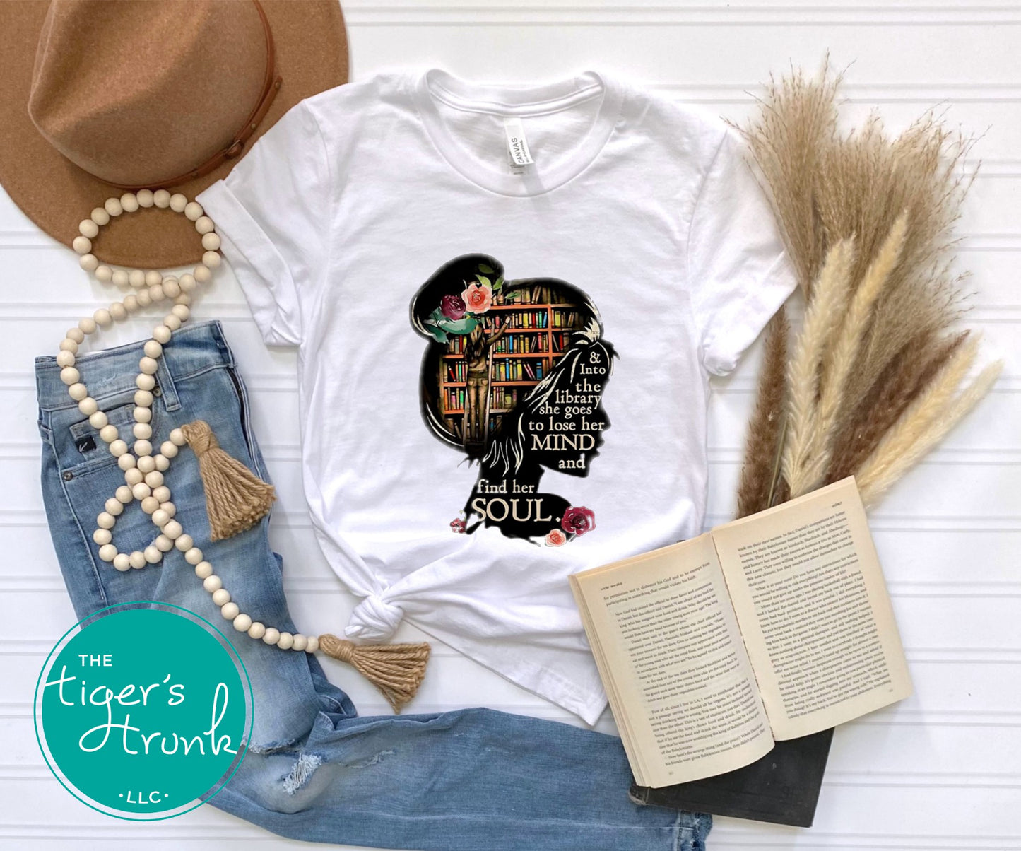 T-shirt with the quote "And to the Library She Goes to Lose Her Mind and Find Her Soul," perfect for readers and book lovers