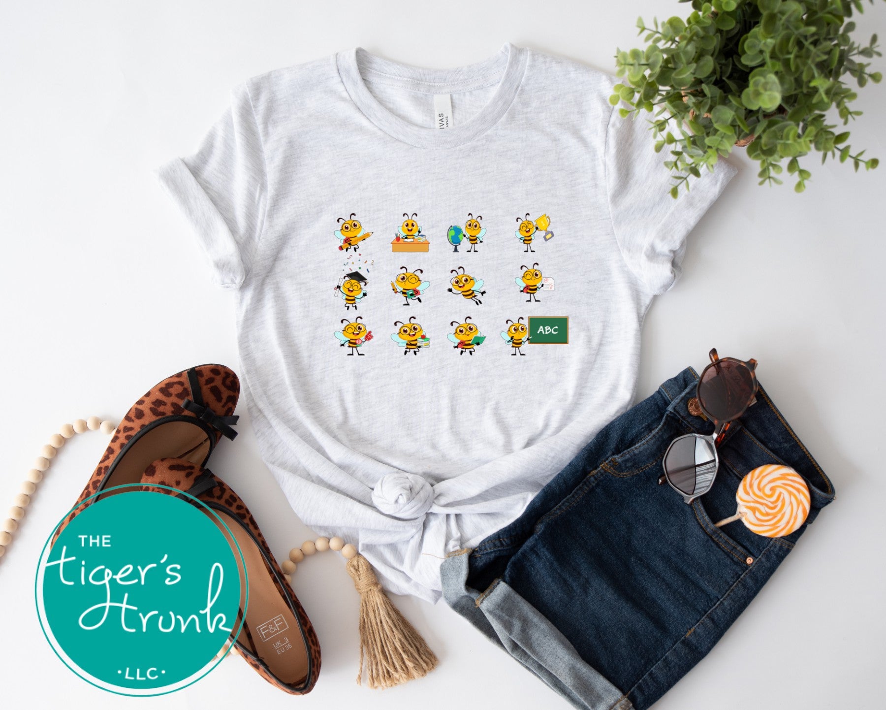 Graphic t-shirt with cartoon bees doing teacher tasks, playful and fun design perfect for school staff and educators