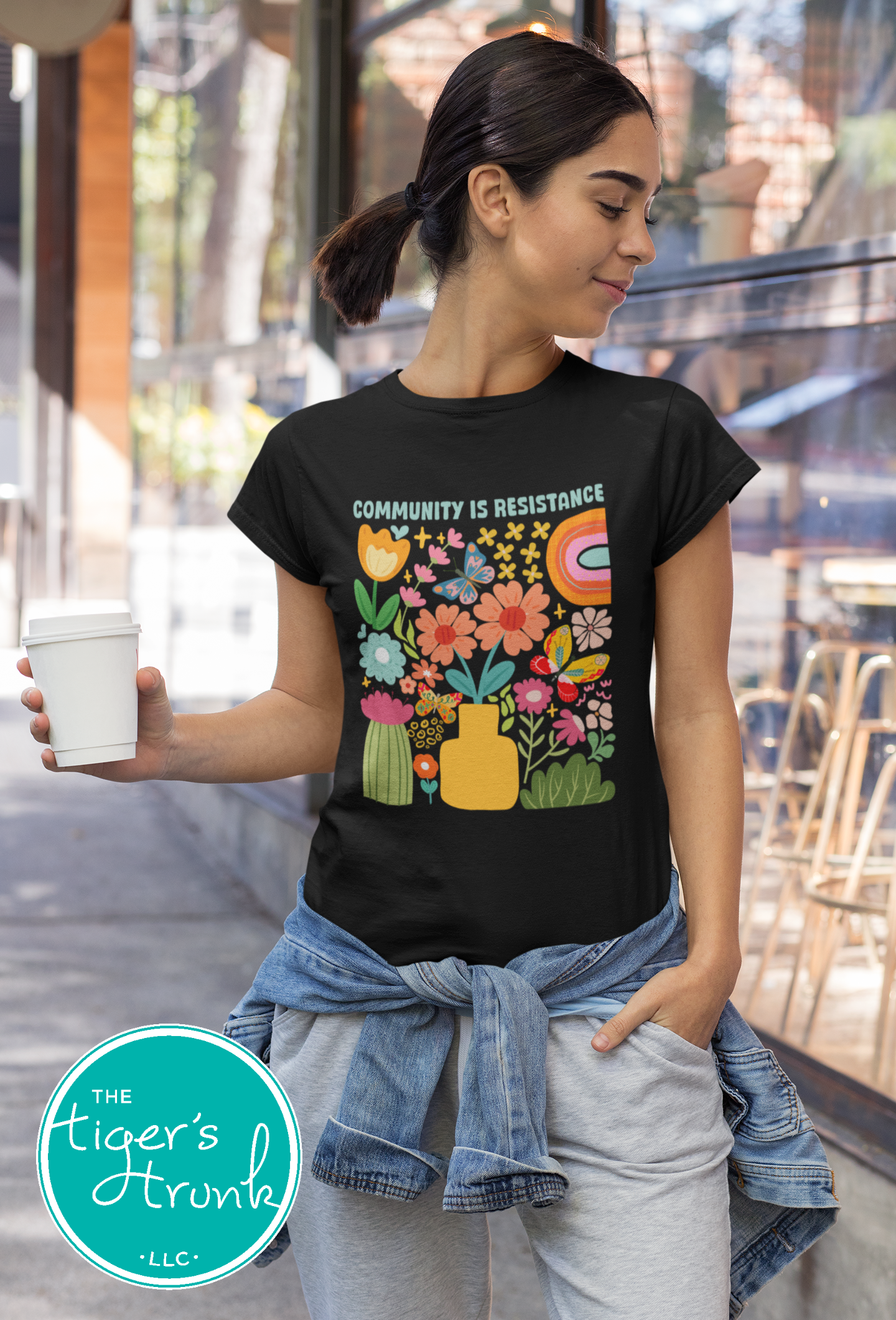 Graphic t-shirt with the phrase "Community Is Resistance," activist apparel for social justice supporters and movement organizers