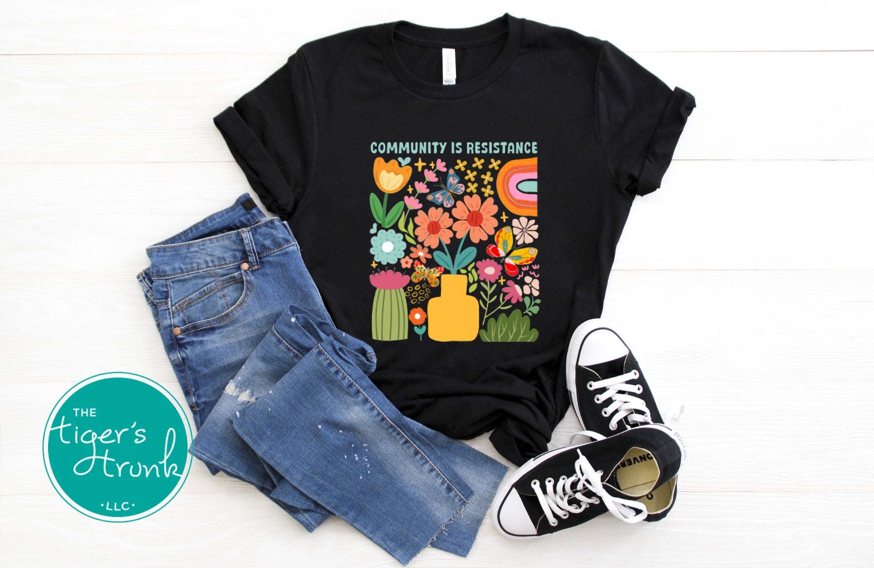 Graphic t-shirt with the phrase "Community Is Resistance," activist apparel for social justice supporters and movement organizers