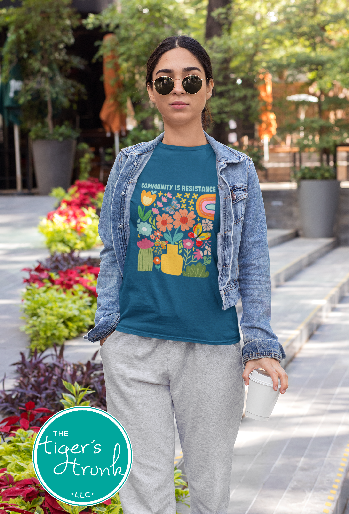 Graphic t-shirt with the phrase "Community Is Resistance," activist apparel for social justice supporters and movement organizers