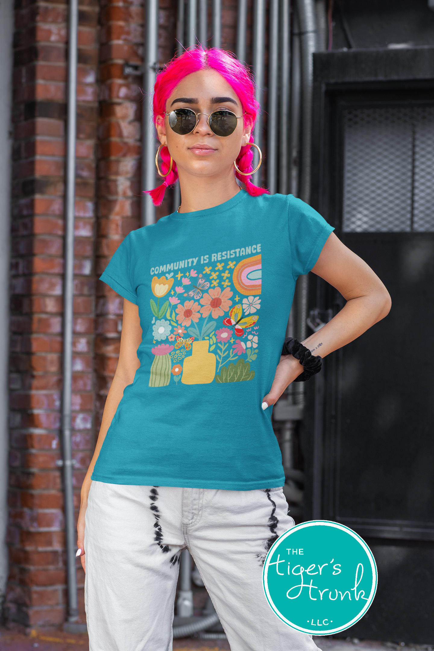 Graphic t-shirt with the phrase "Community Is Resistance," activist apparel for social justice supporters and movement organizers