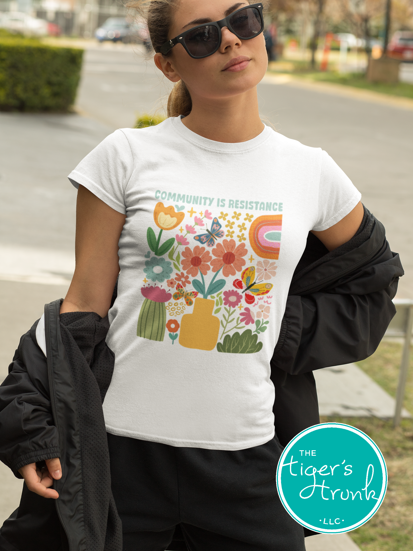 Graphic t-shirt with the phrase "Community Is Resistance," activist apparel for social justice supporters and movement organizers