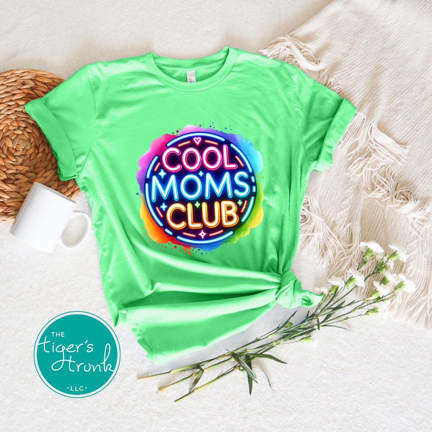Graphic t-shirt with Cool Mom's Club text in neon colors, fun and trendy design for stylish moms