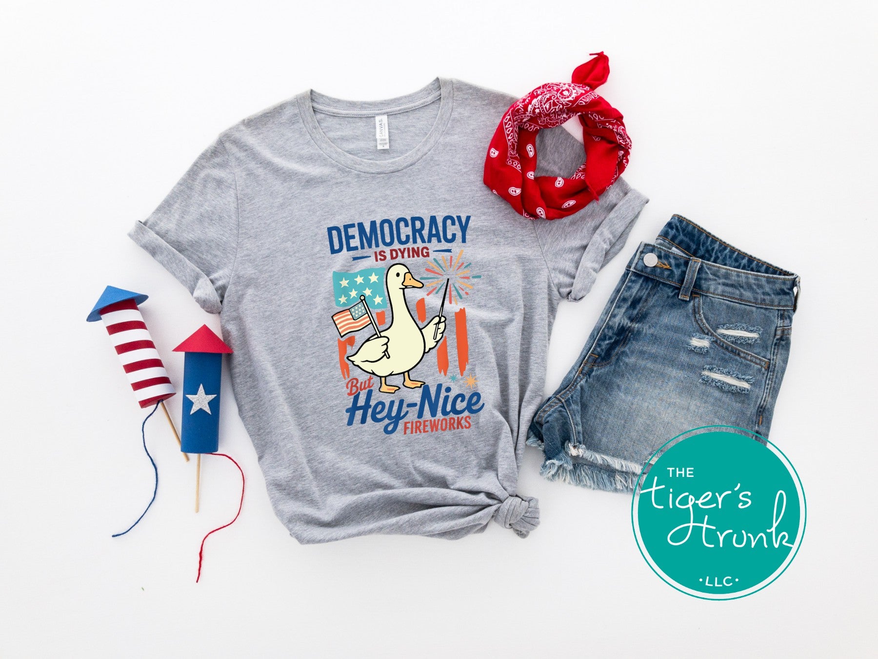 Funny Fourth of July t-shirt with goose holding sparkler and flag, reading Democracy Is Dying But Hey, Nice Fireworks