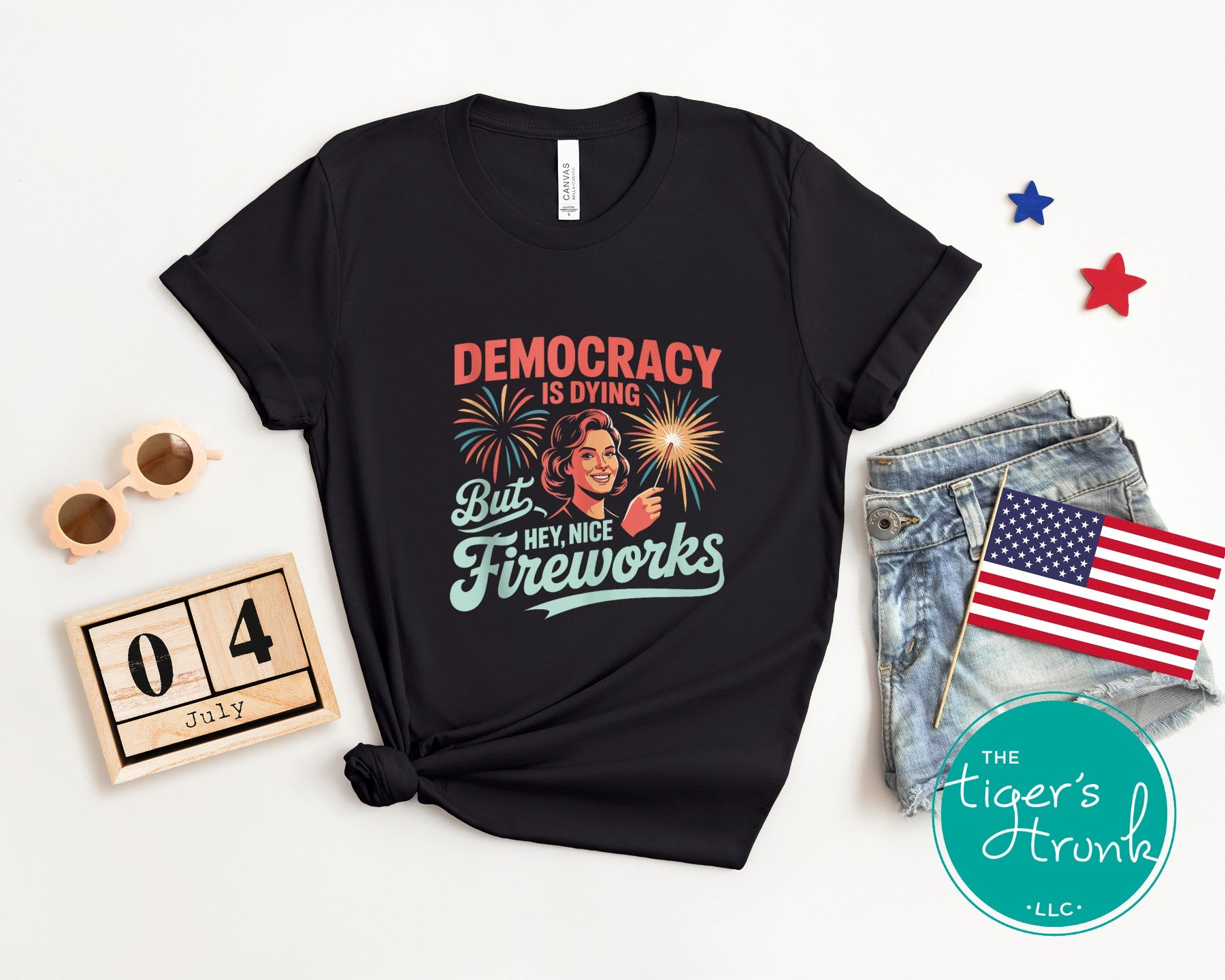 Patriotic graphic t-shirt that reads Democracy Is Dying But Hey, Nice Fireworks, political and sarcastic July Fourth shirt