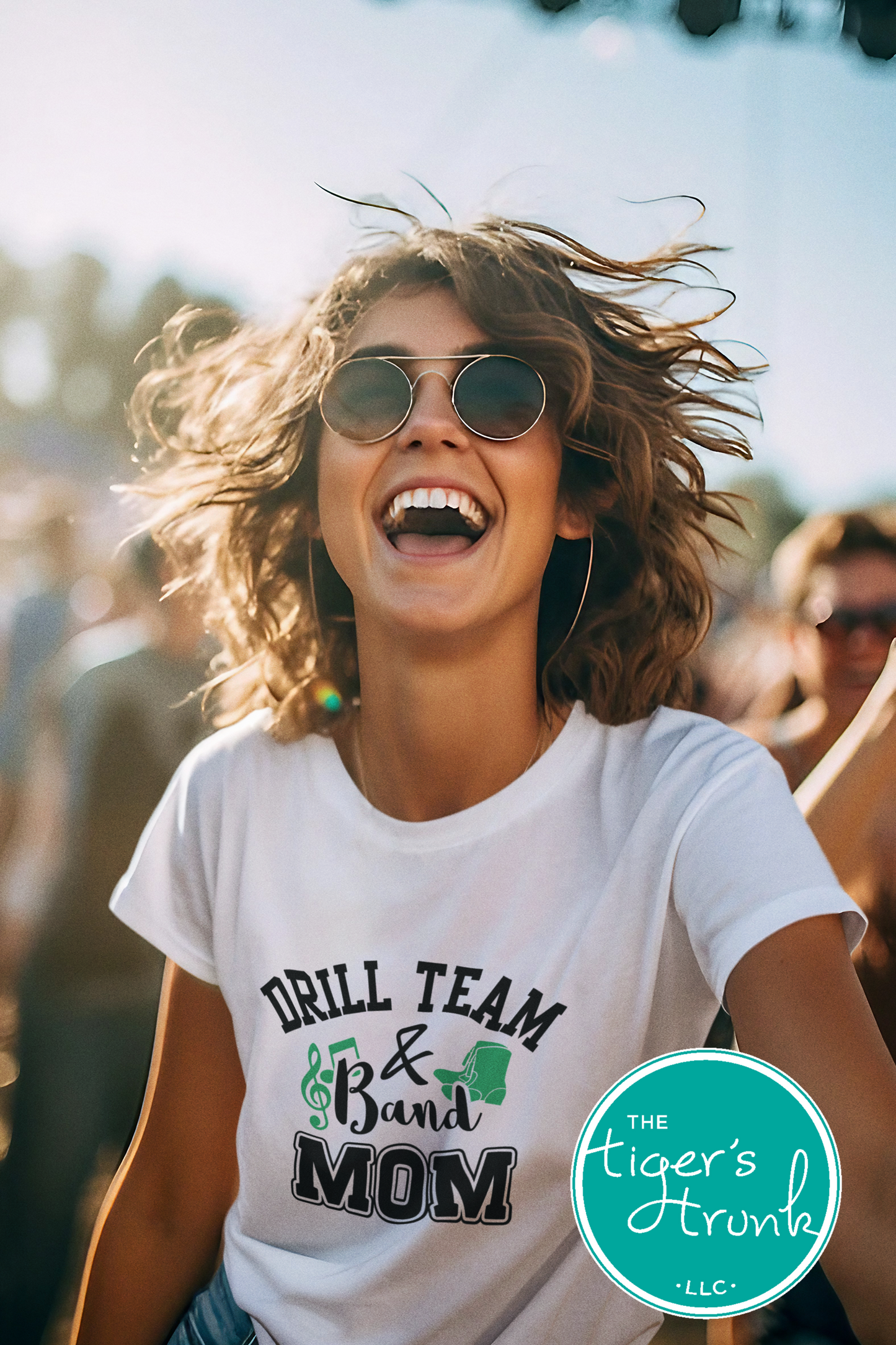 Woman wearing a 'Drill Team & Band Mom' t-shirt at an outdoor event.