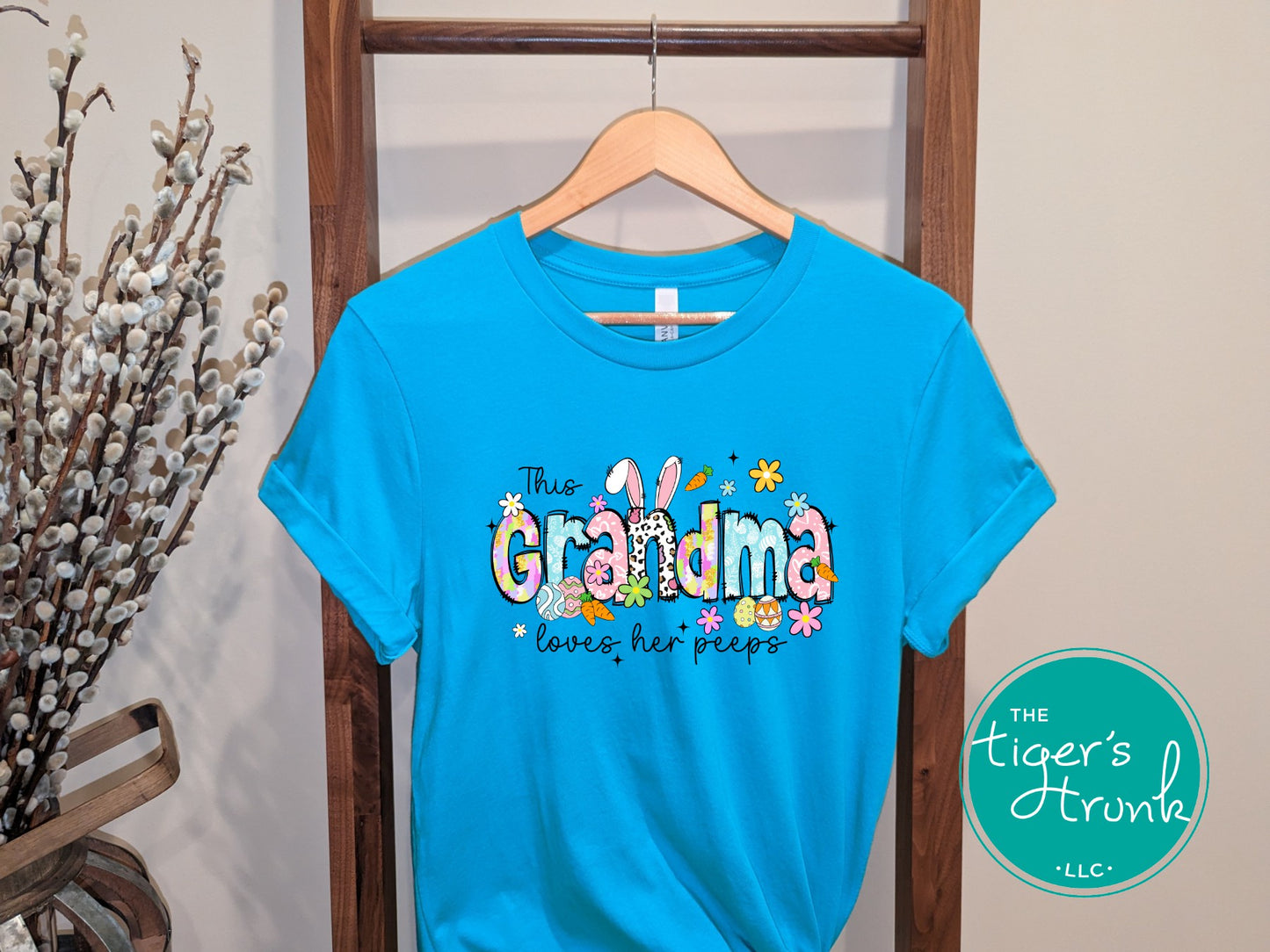 Easter t-shirt with "Grandma" in pastel spring print font featuring bunnies, florals, and eggs, perfect for Easter brunch and family gatherings