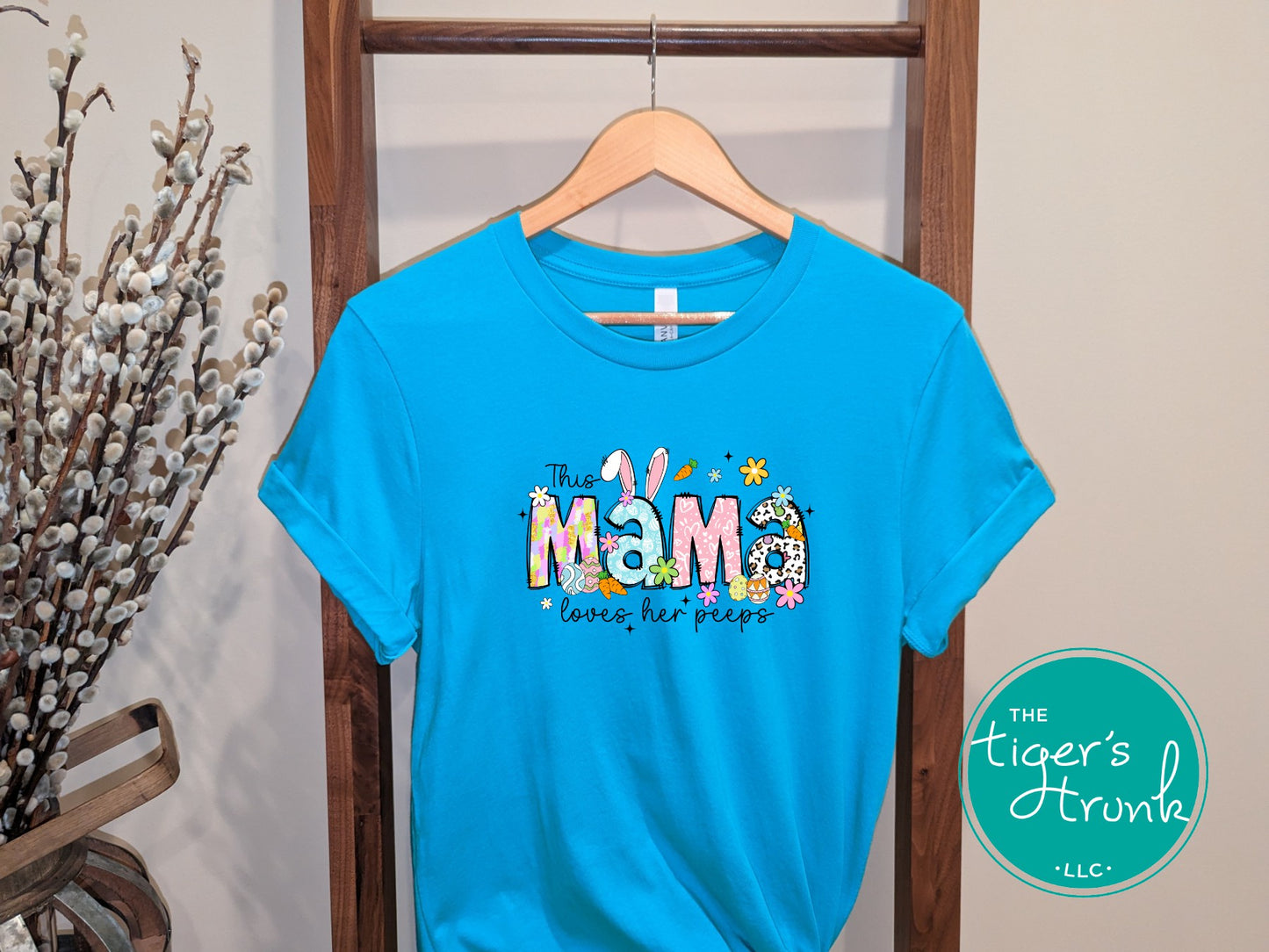Easter t-shirt with "Mama" in colorful pastel spring print font, featuring floral and bunny-themed design perfect for holiday celebrations