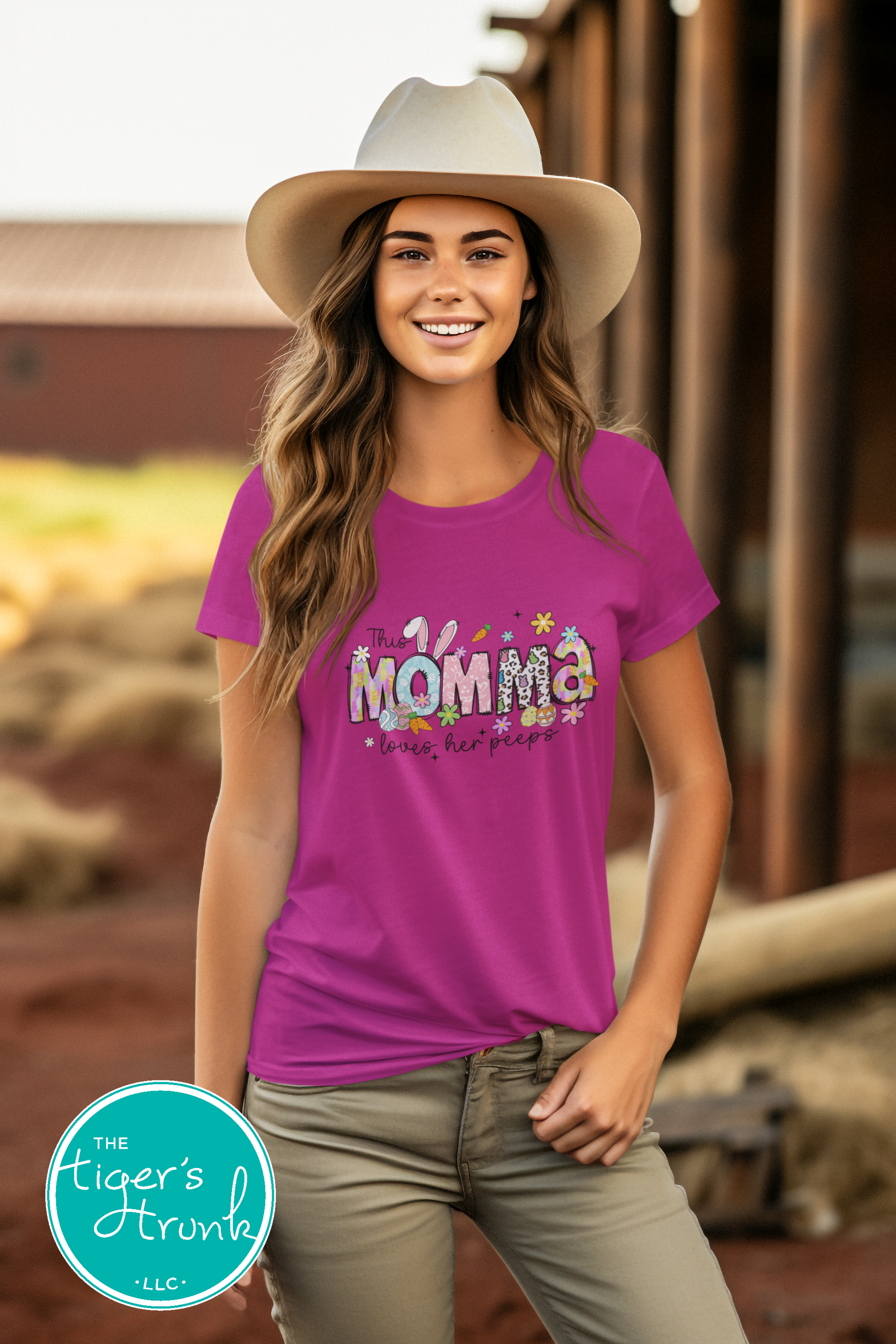 Easter t-shirt with "Momma" in colorful spring-themed font including bunnies, eggs, and florals, perfect for Easter gatherings