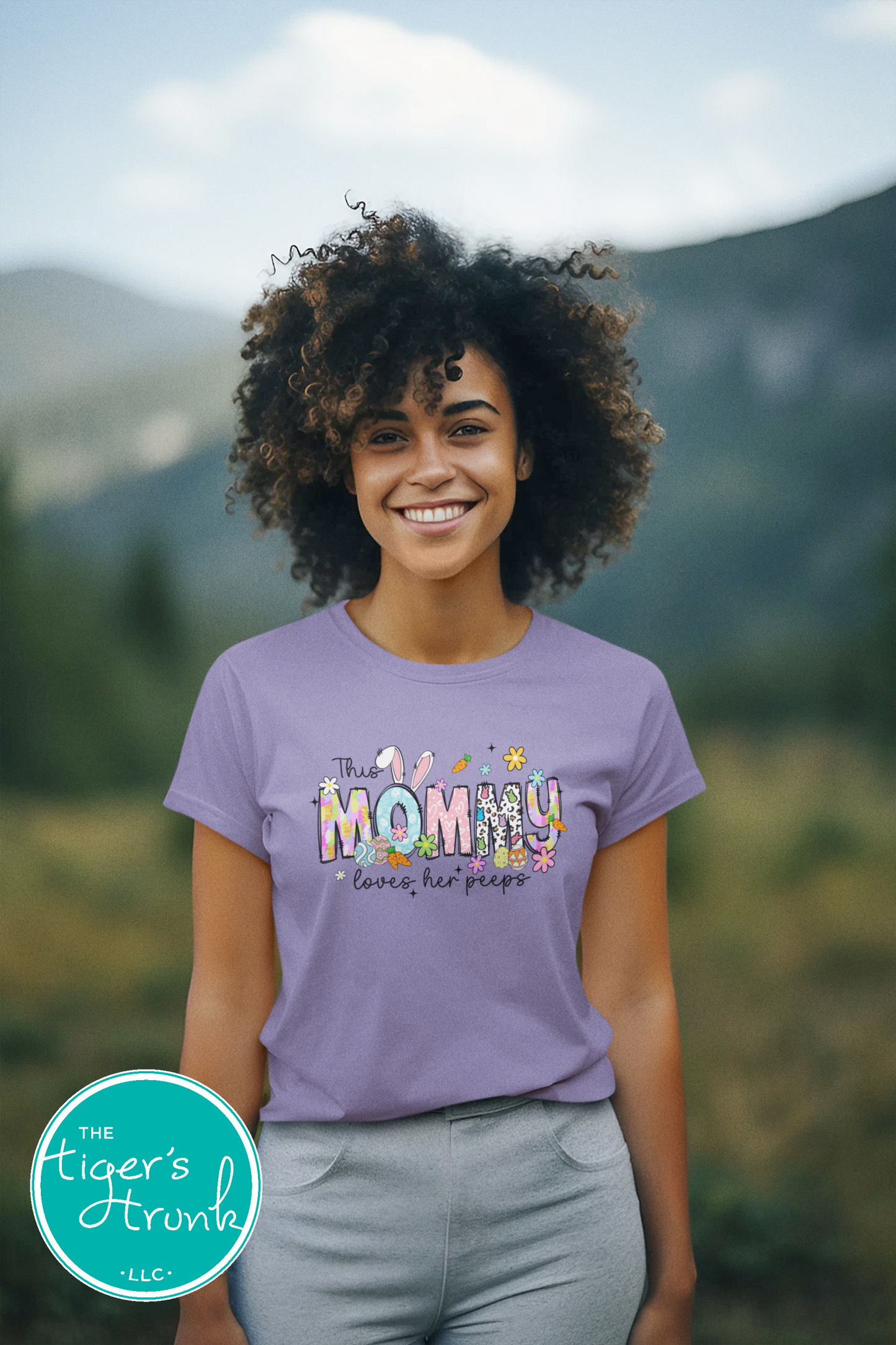 Easter t-shirt with "Mommy" in spring print font featuring bunnies, eggs, and flowers, perfect for holiday wear and family gatherings