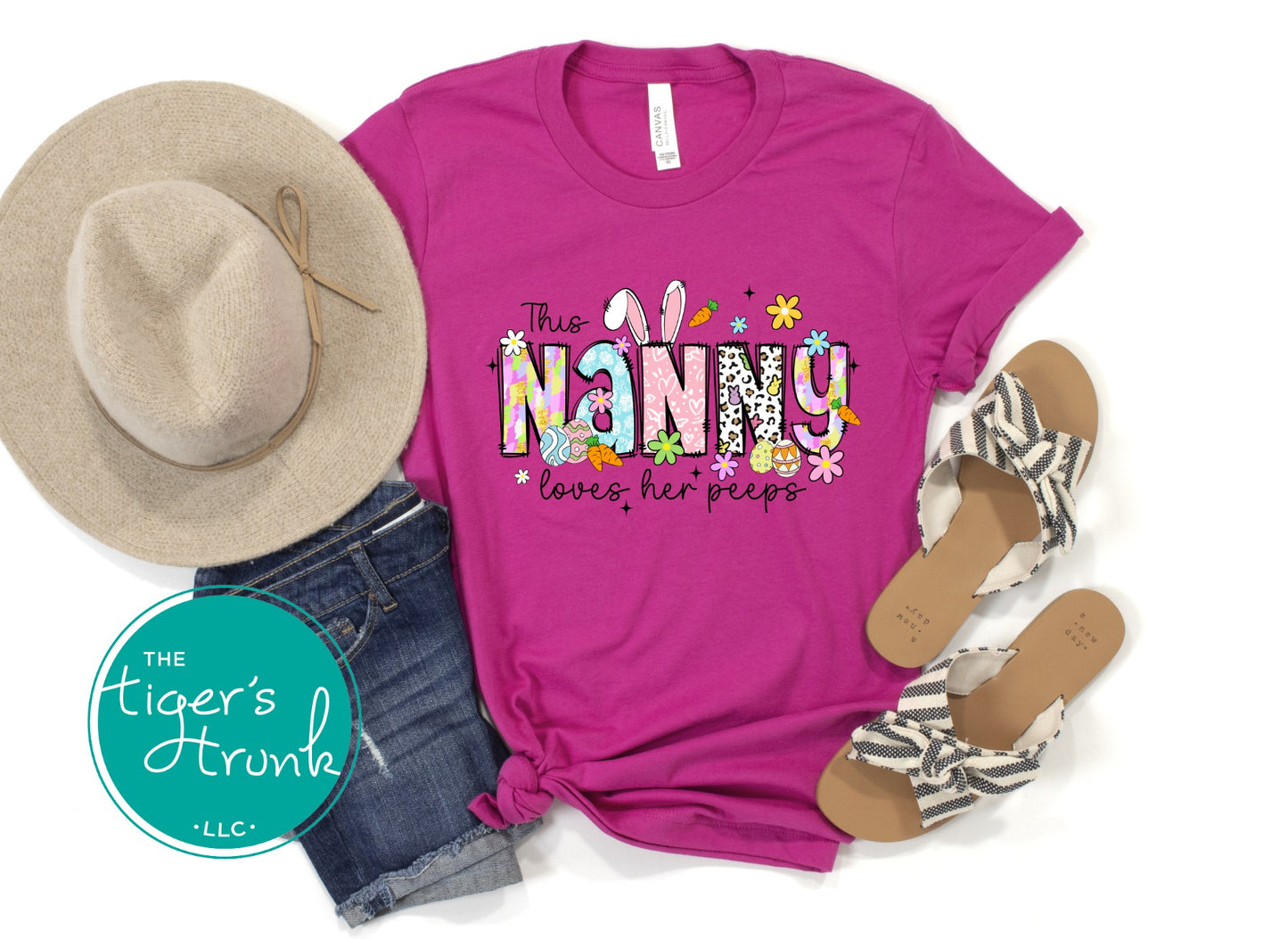 Easter t-shirt with "Nanny" in spring print font decorated with bunnies, eggs, and flowers, perfect for holiday wear and springtime fun