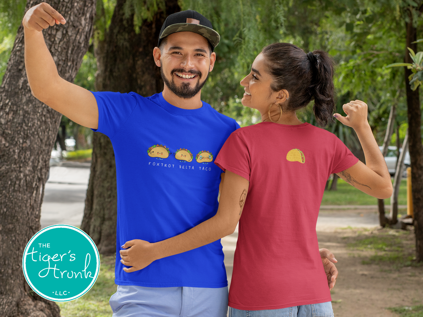 Two people wearing blue and red t-shirts with graphic designs, standing outdoors.