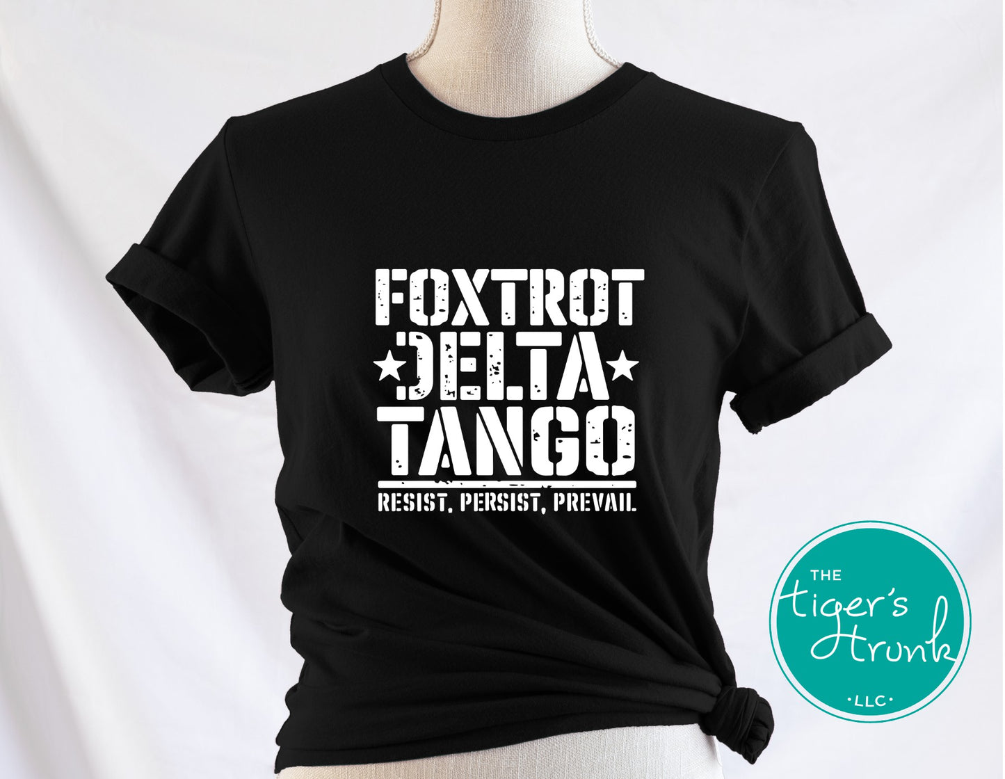 Black t-shirt with white text on a mannequin against a white background, featuring the brand 'The Tiger's Trunk'.