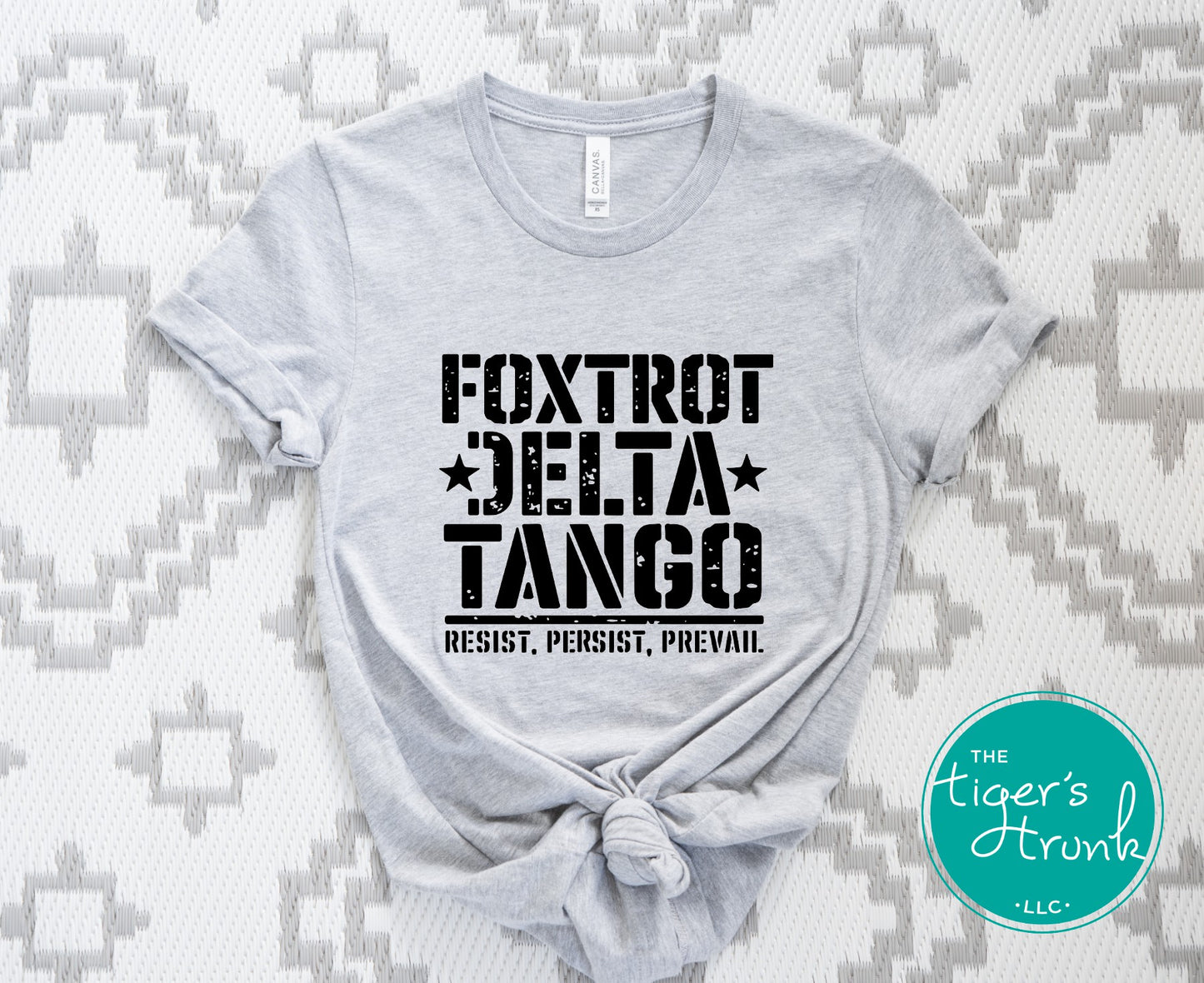 Gray t-shirt with 'Foxtrot Delta Tango' text on a patterned background