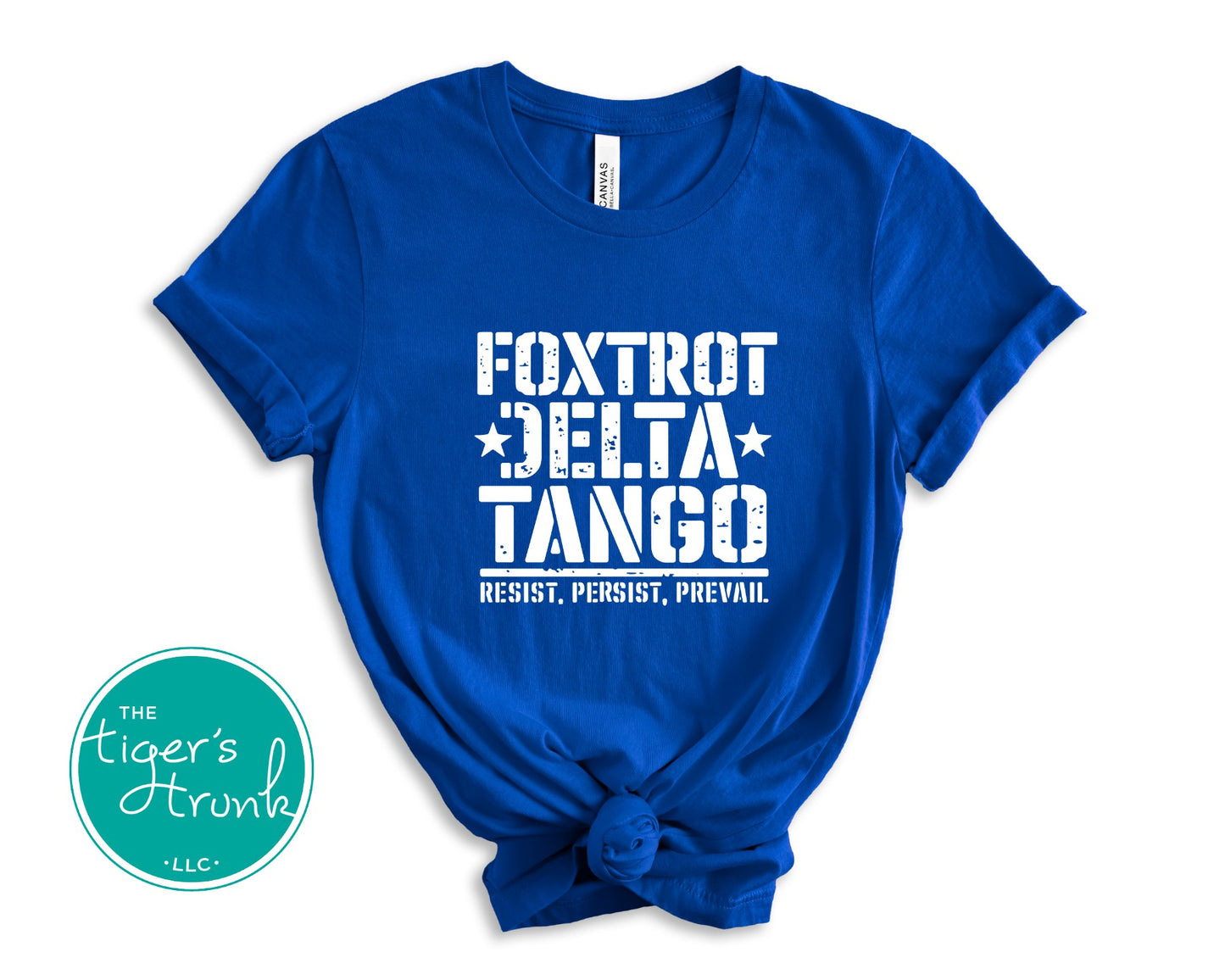 Blue t-shirt with white text 'Foxtrot Delta Tango' and 'The Tiger's Trunk' logo on a white background