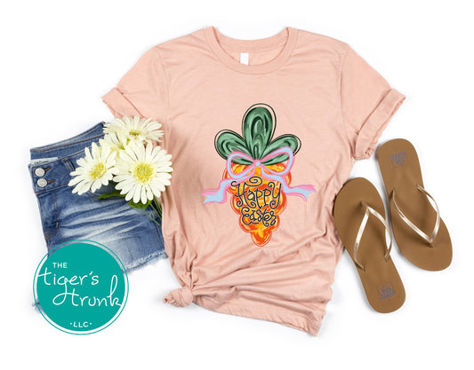 Easter t-shirt with Happy Easter text and watercolor carrot design, soft pastel spring look perfect for the holiday season.
