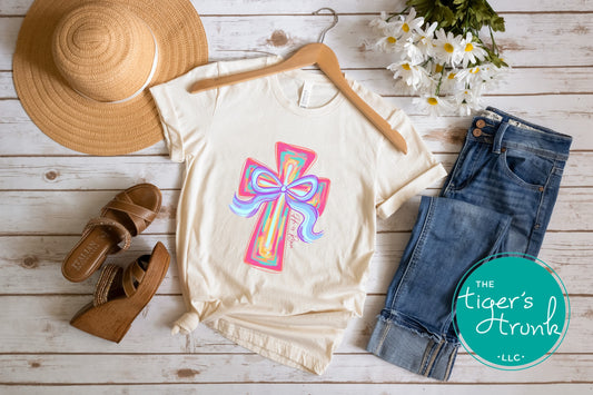 Christian Easter t-shirt with watercolor cross and He Is Risen message, designed for faith-based spring celebrations