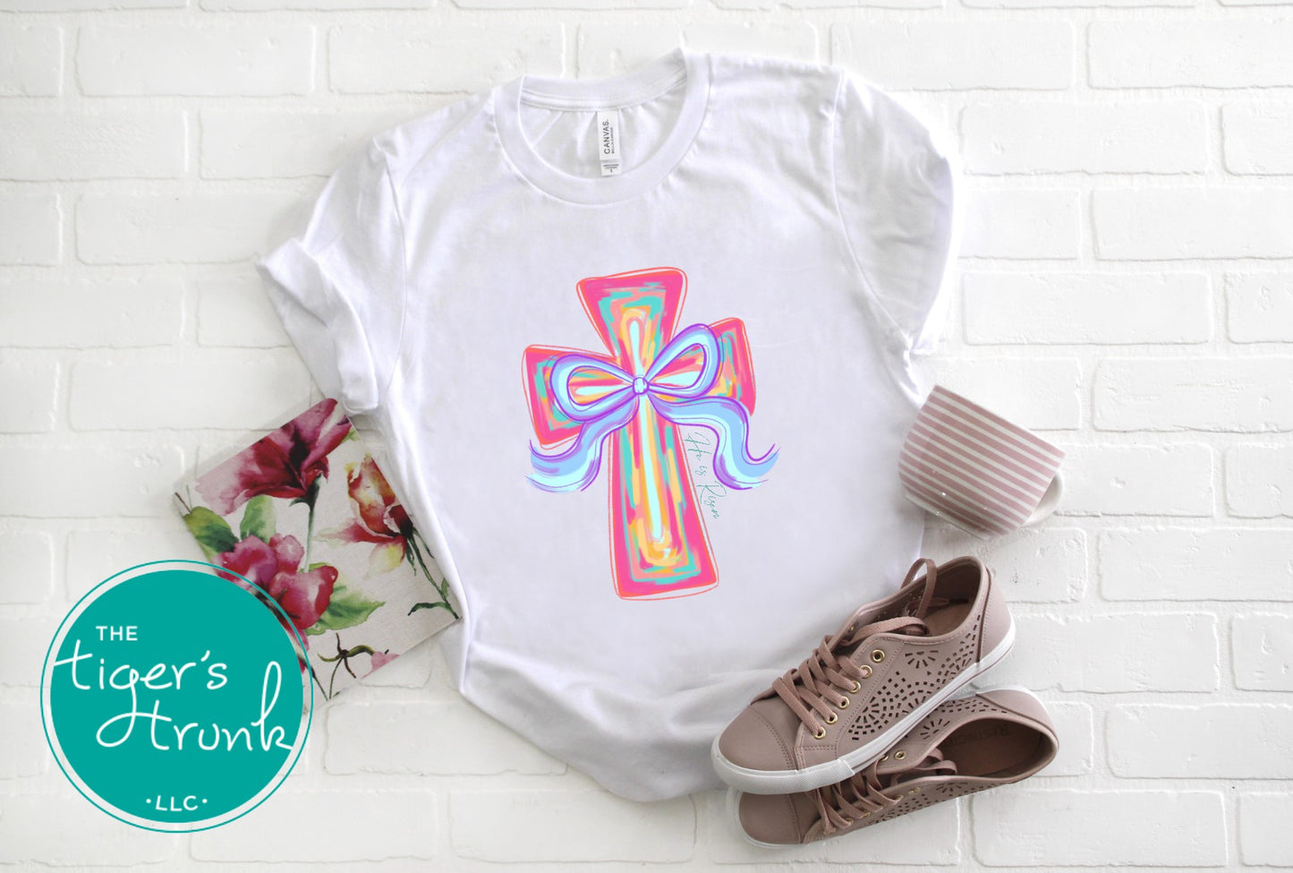 Christian Easter t-shirt with watercolor cross and He Is Risen message, designed for faith-based spring celebrations