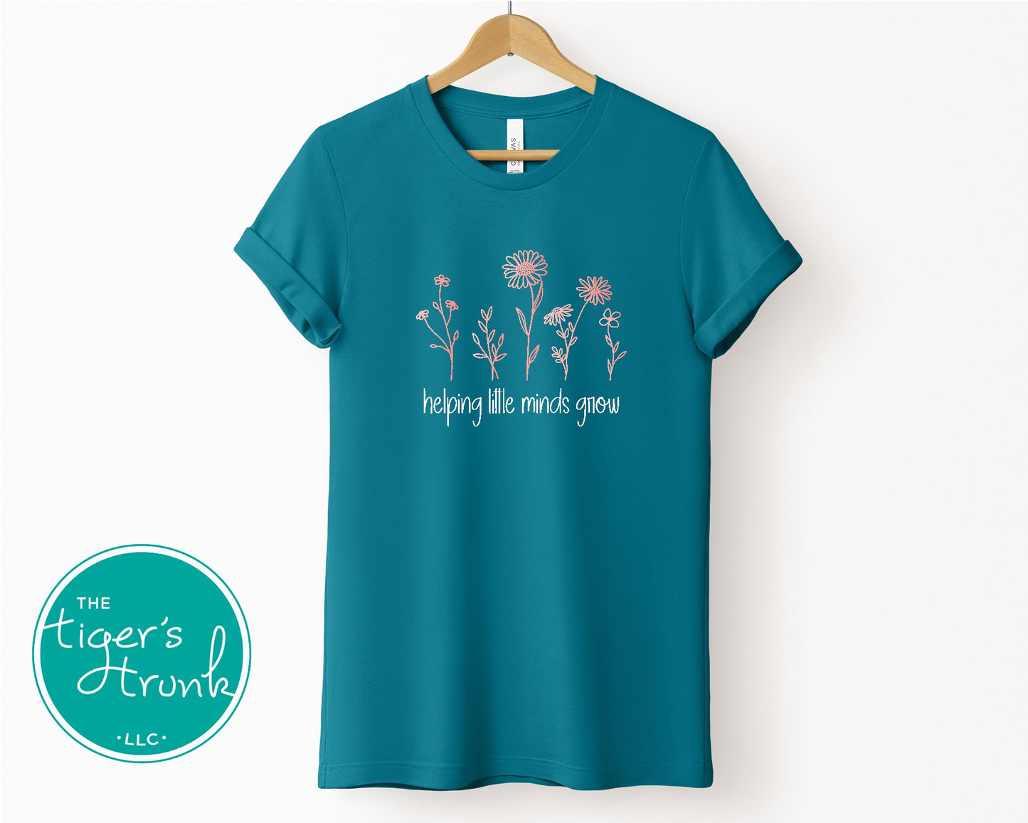 T-shirt with wildflowers and the phrase "Helping Little Minds Grow," a soft and inspiring design for educators and school staff