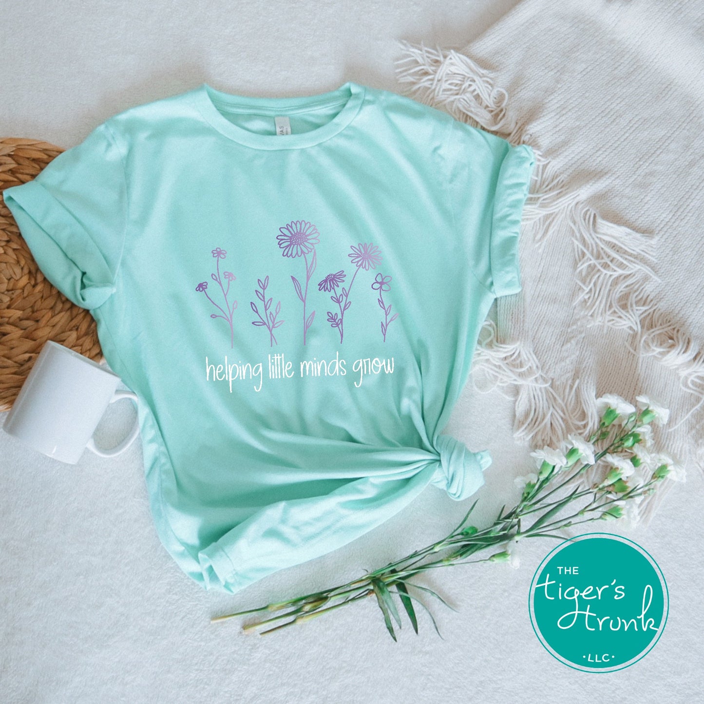 T-shirt with wildflowers and the phrase "Helping Little Minds Grow," a soft and inspiring design for educators and school staff
