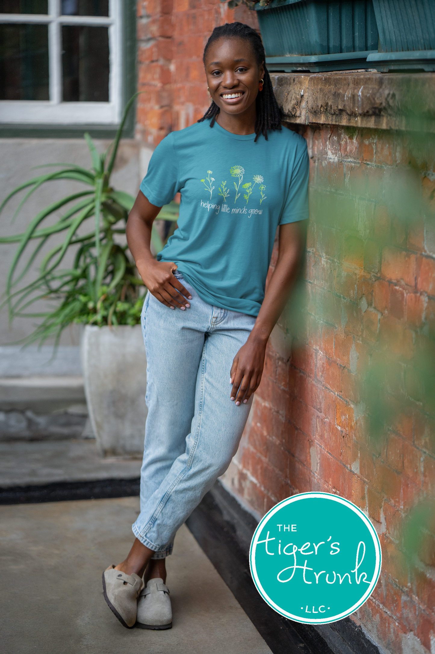 T-shirt with wildflowers and the phrase "Helping Little Minds Grow," a soft and inspiring design for educators and school staff
