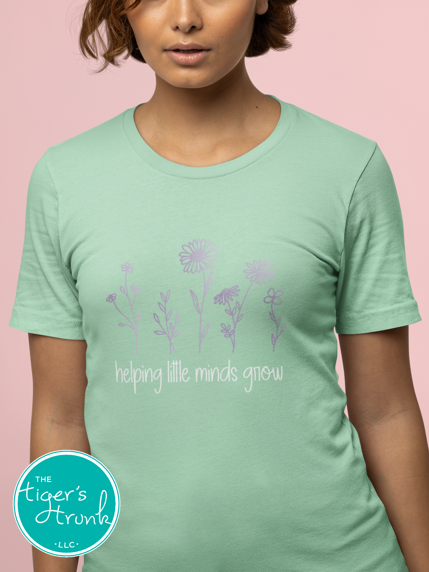 T-shirt with wildflowers and the phrase "Helping Little Minds Grow," a soft and inspiring design for educators and school staff