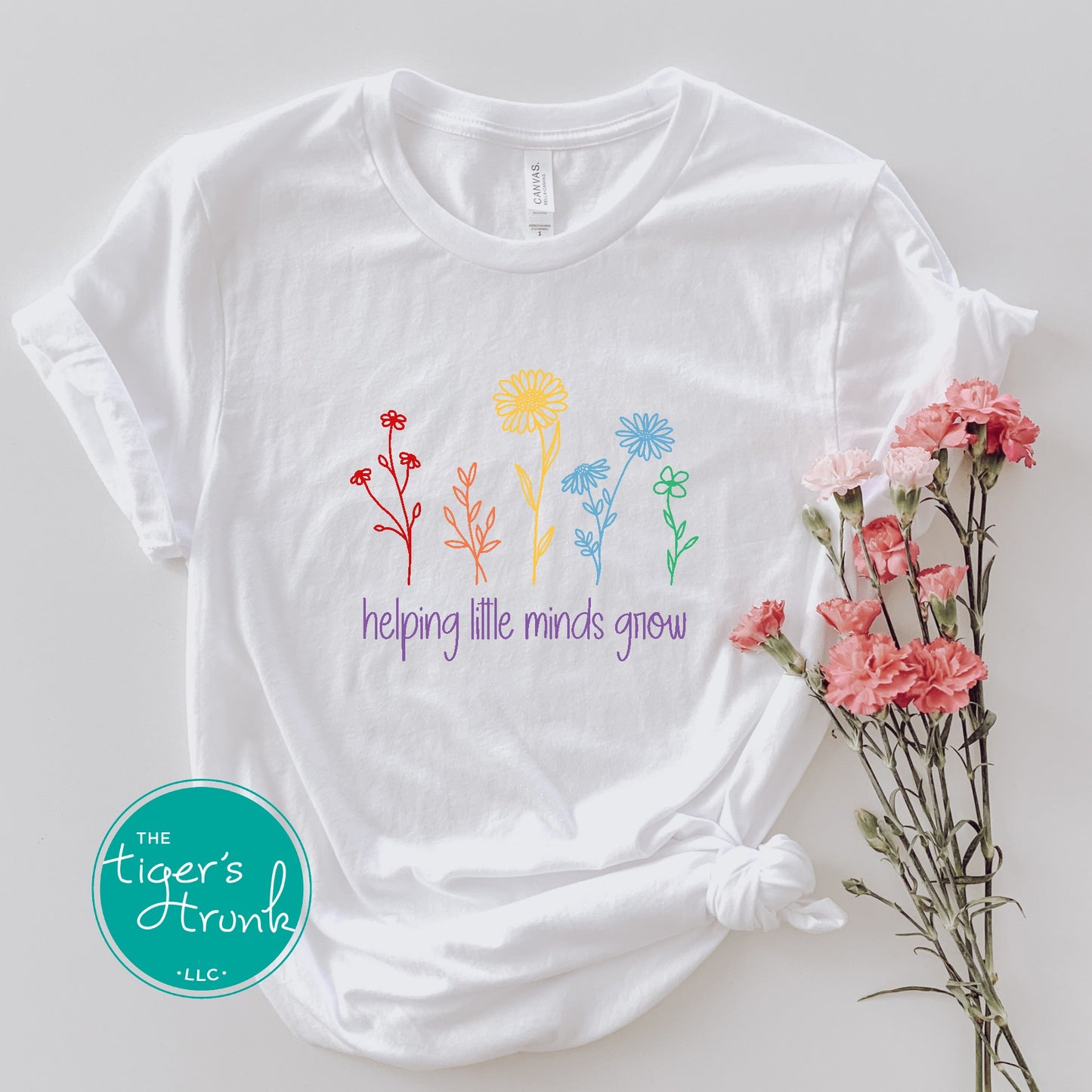 T-shirt with wildflowers and the phrase "Helping Little Minds Grow," a soft and inspiring design for educators and school staff