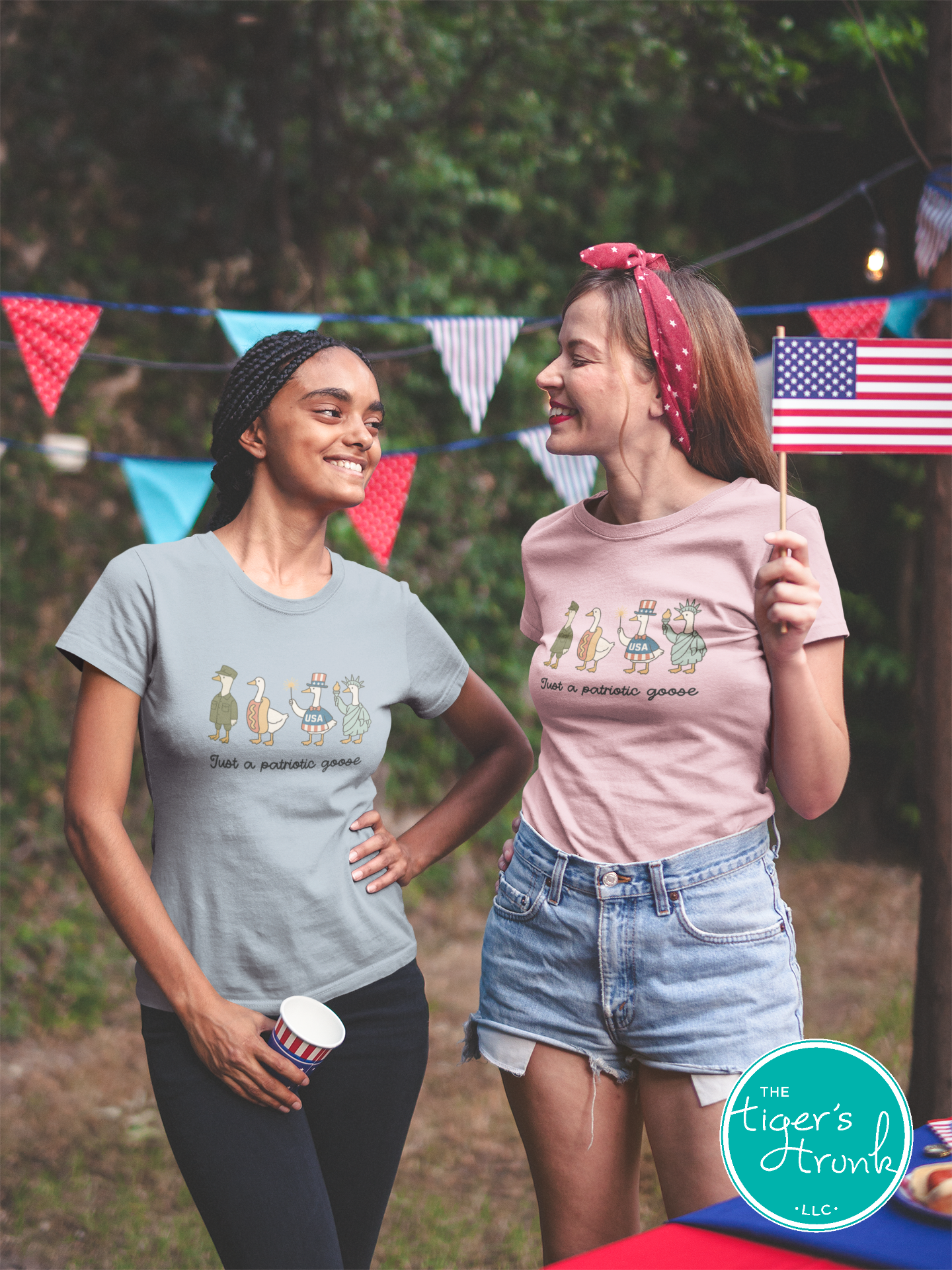 Funny patriotic t-shirt with four geese dressed as a soldier, hotdog, statue, and red-white-blue icon, reading Just a Patriotic Goose