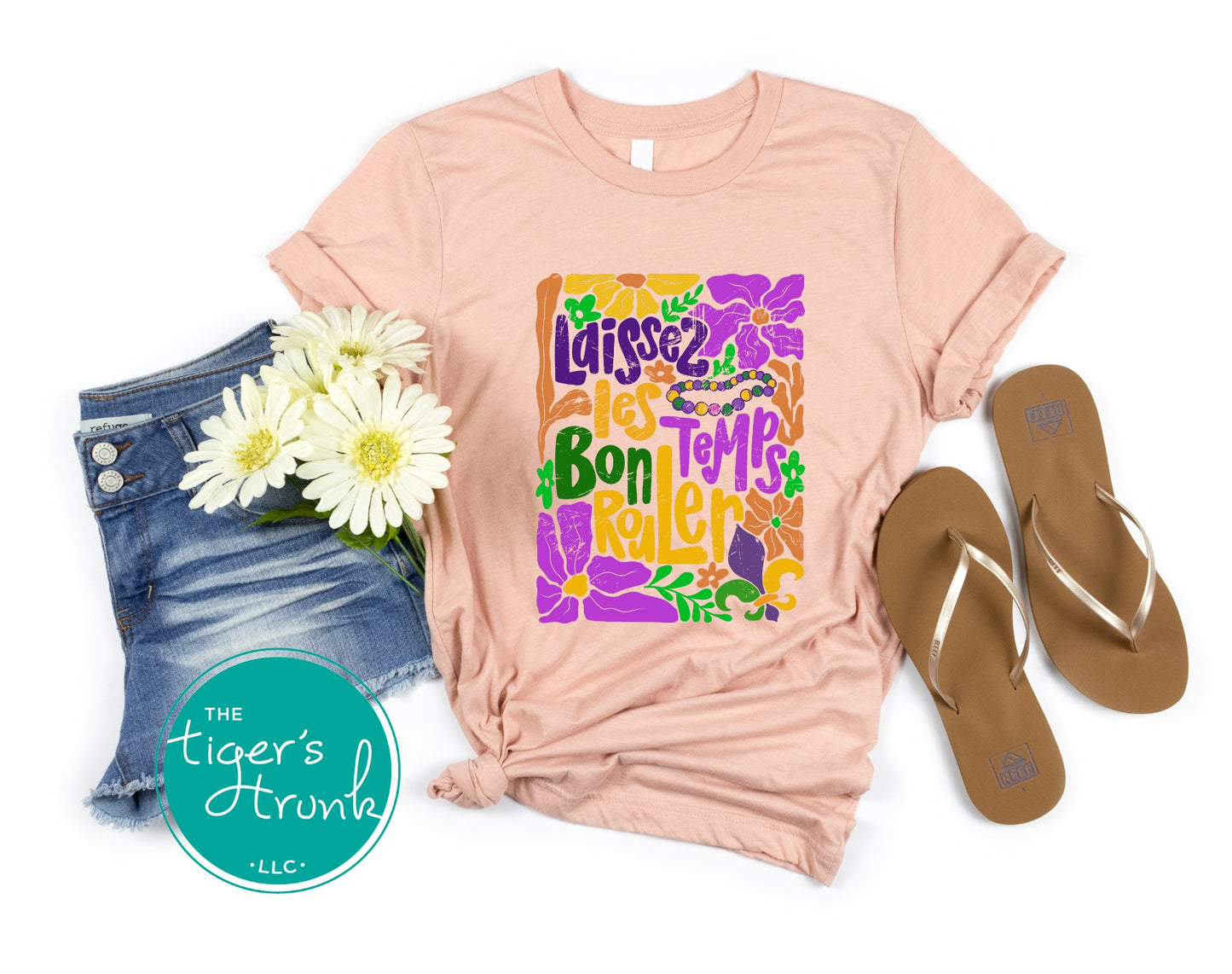 Tropical vintage-style Mardi Gras t-shirt with the phrase "Laissez les Bon Temps Rouler" in classic purple, green, and gold colors.