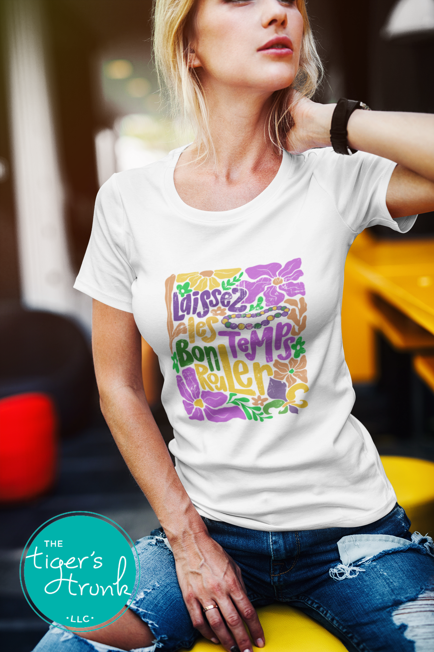 Tropical vintage-style Mardi Gras t-shirt with the phrase "Laissez les Bon Temps Rouler" in classic purple, green, and gold colors.