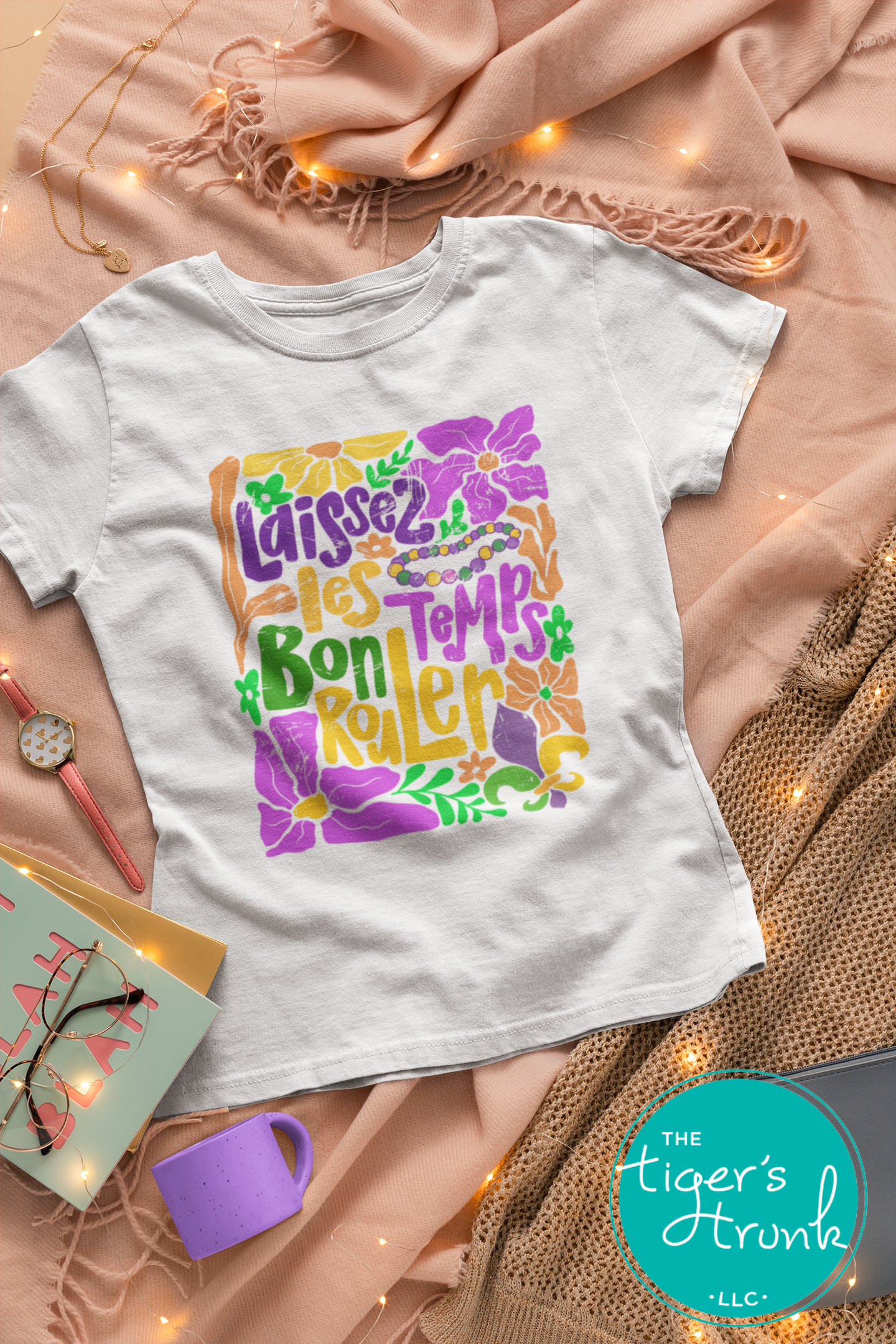 Tropical vintage-style Mardi Gras t-shirt with the phrase "Laissez les Bon Temps Rouler" in classic purple, green, and gold colors.