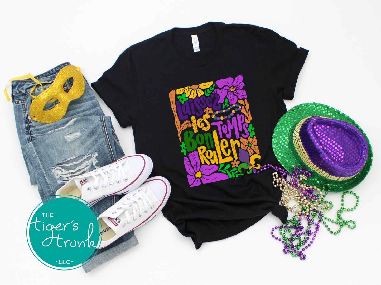 Tropical vintage-style Mardi Gras t-shirt with the phrase "Laissez les Bon Temps Rouler" in classic purple, green, and gold colors.