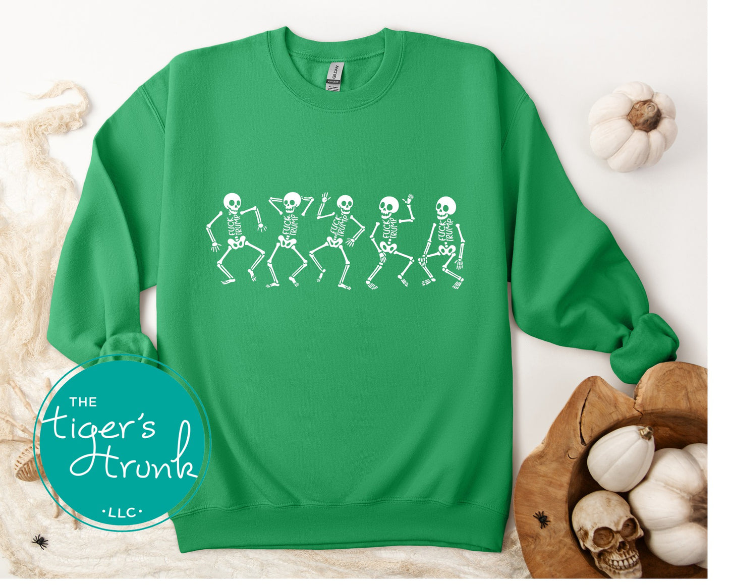 Green sweatshirt with skeleton design on a white background, featuring 'The Tiger's Trunk' logo.
