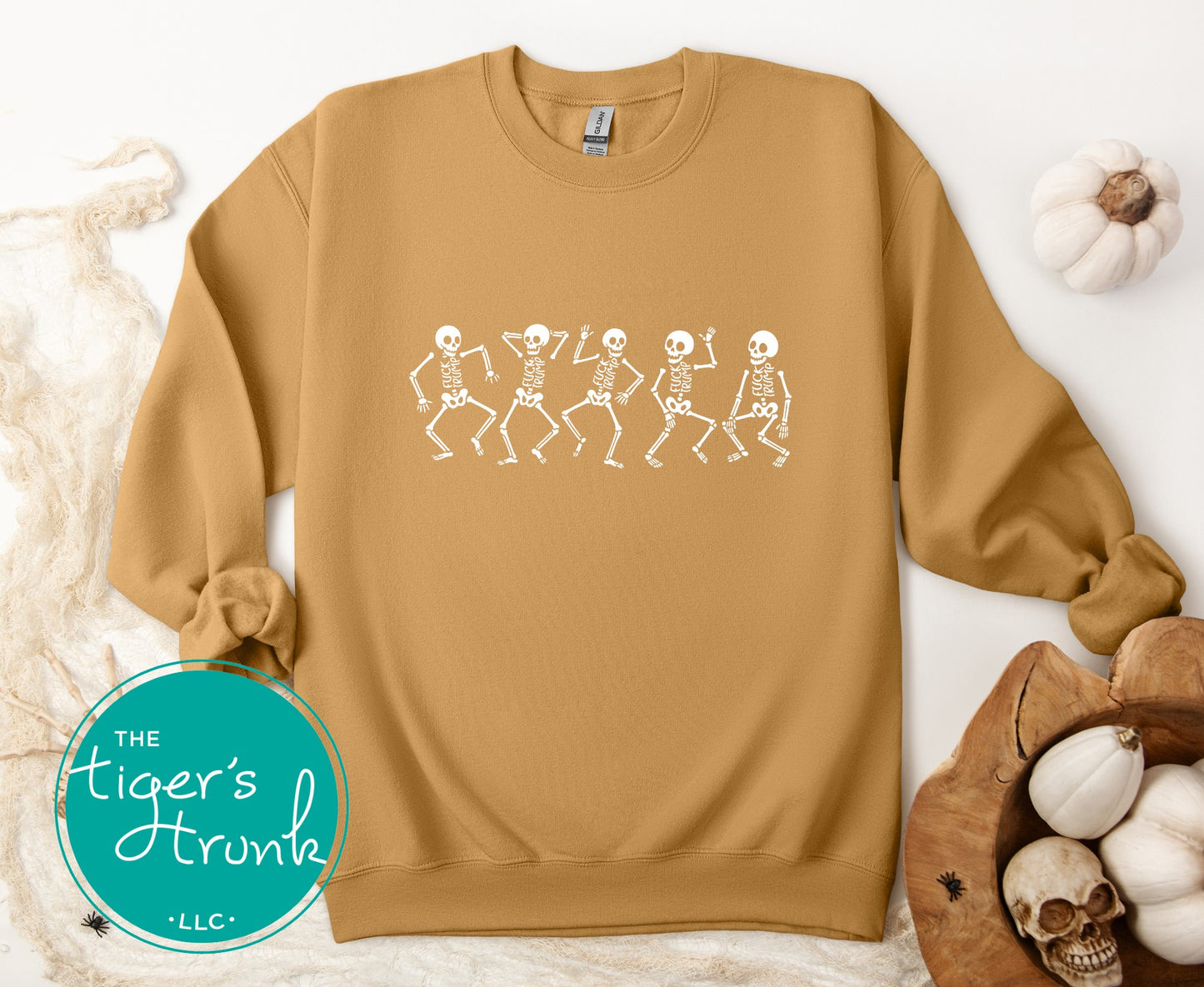 Brown sweatshirt with skeleton design on a white background, featuring 'The Tiger's Trunk' logo.