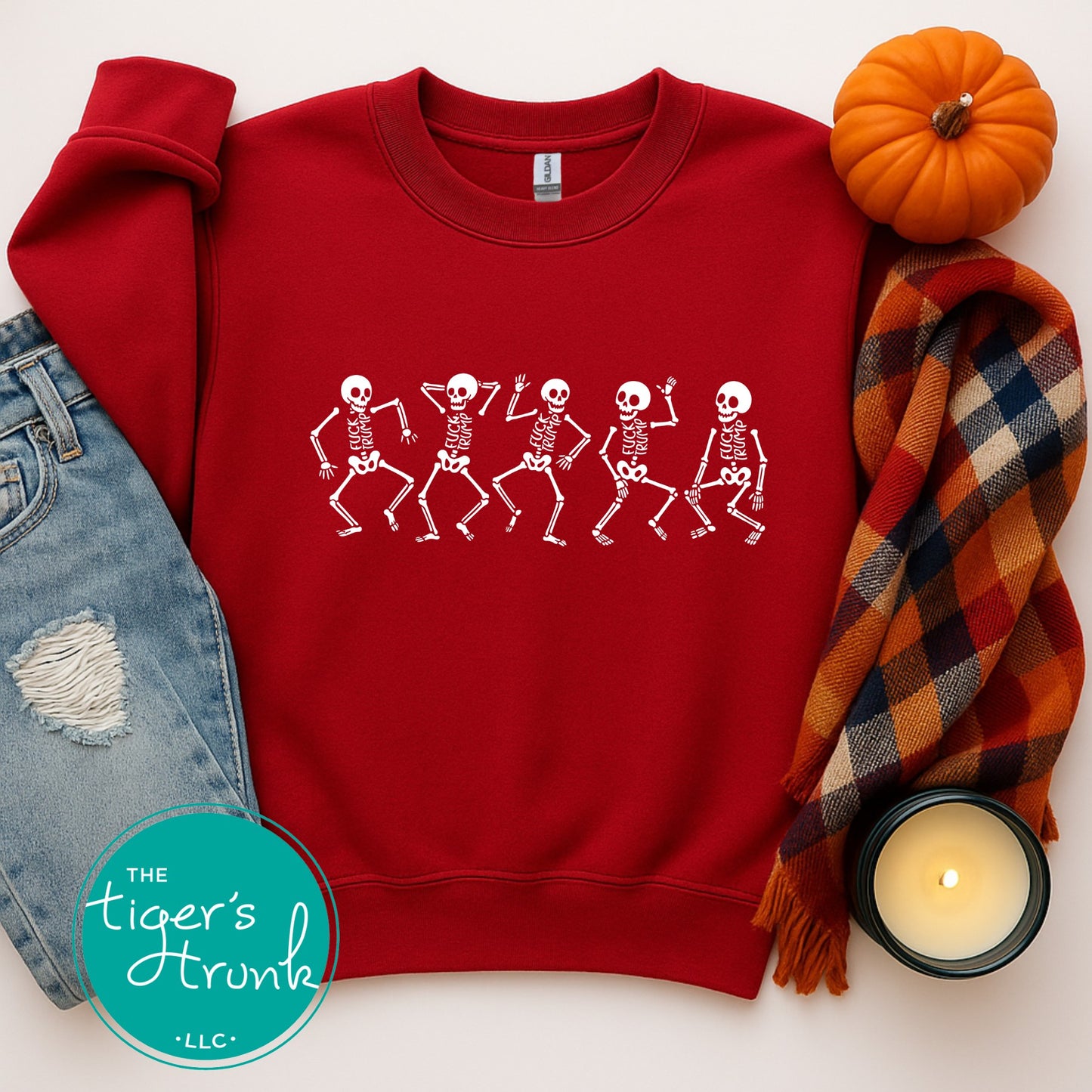 Red sweatshirt with skeleton design, surrounded by autumn-themed items on a white background.