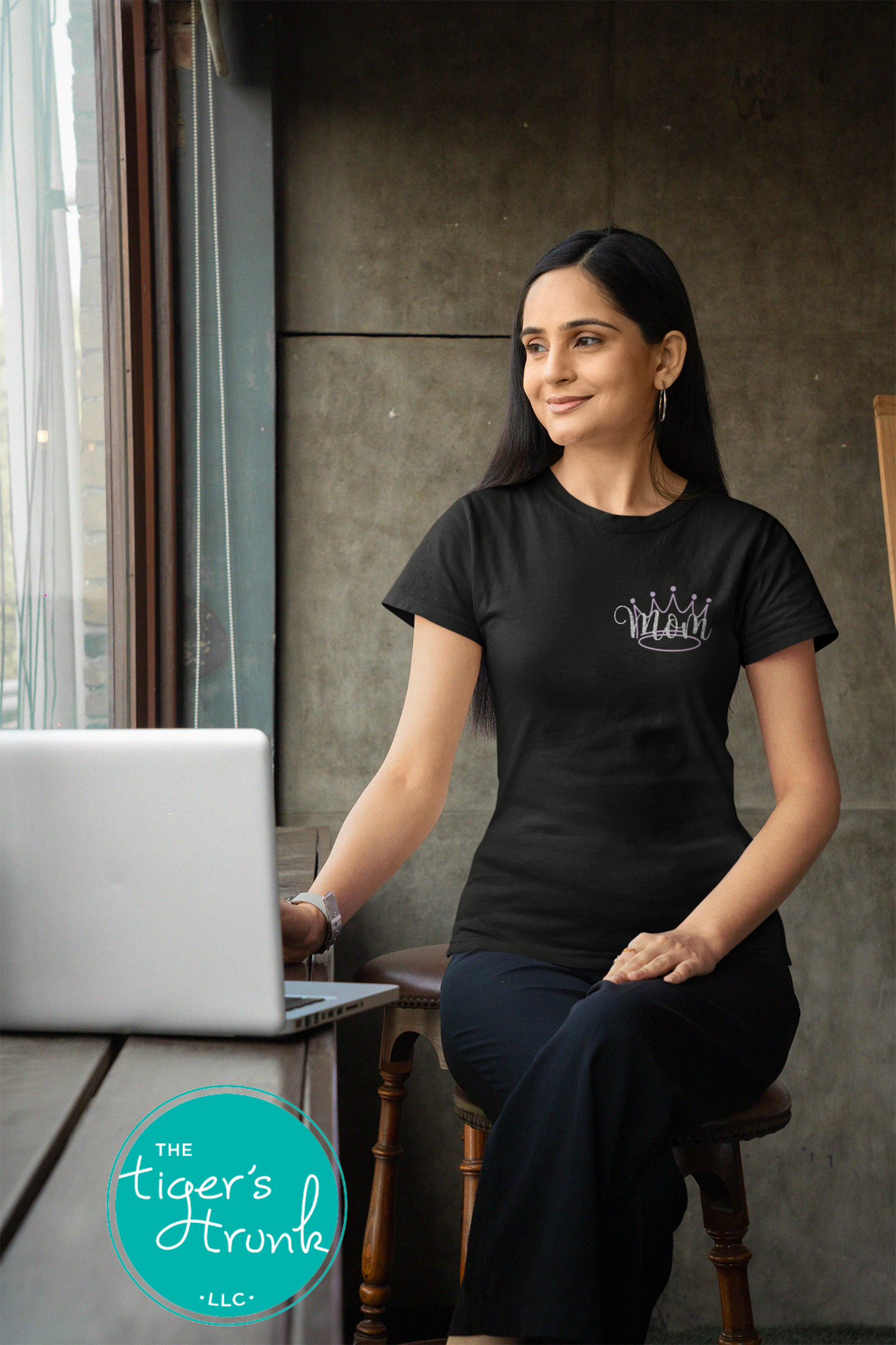 Model wearing black pageant mom shirt with purple crown and “Mom” in script font on the front, personalized on the back with contestant’s name in block letters