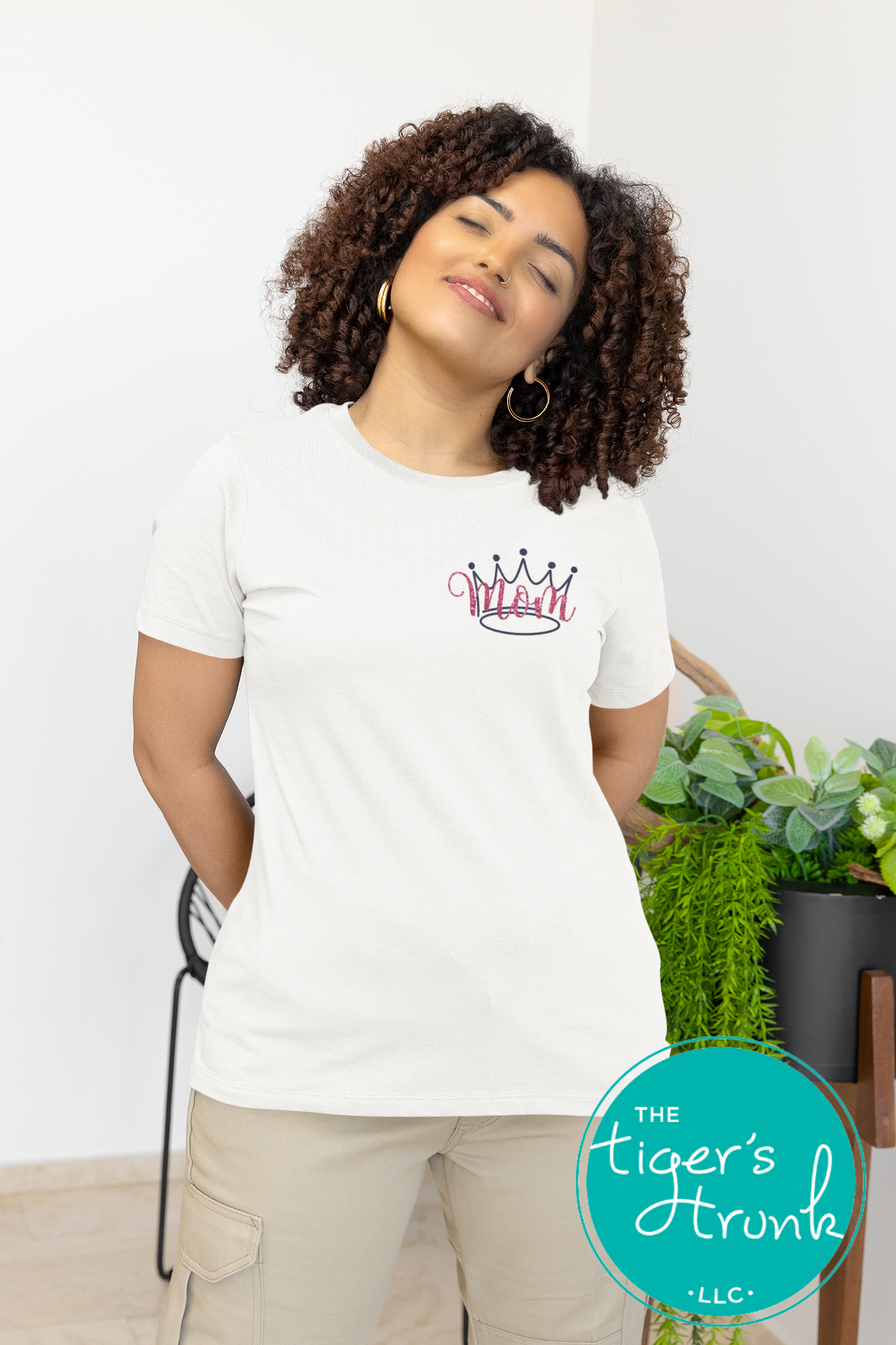 Model wearing white pageant mom shirt with pink crown and “Mom” in script font on the front, personalized on the back with contestant’s name in block letters