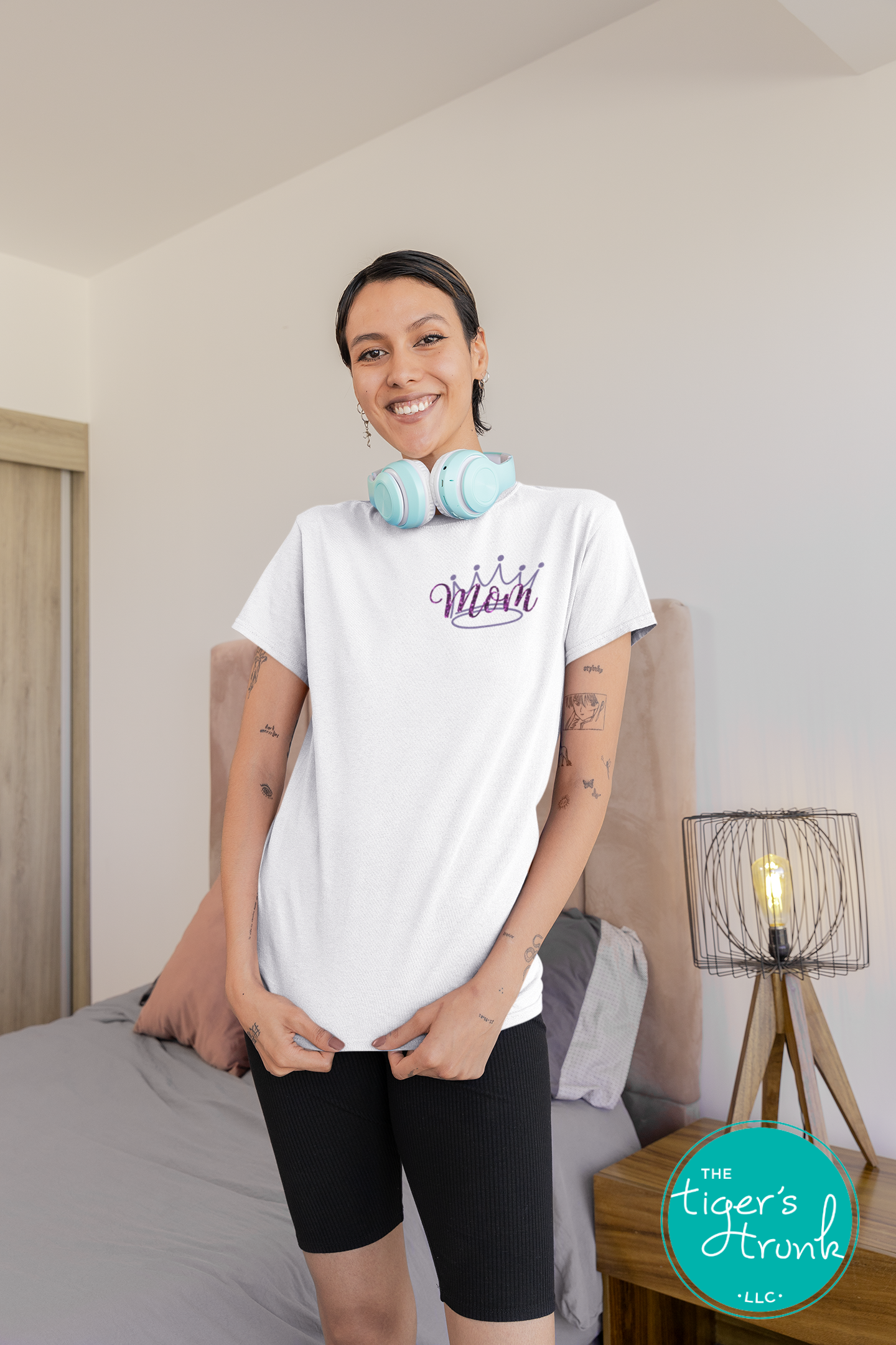 Model wearing white pageant mom shirt with purple crown and “Mom” in script font on the front, personalized on the back with contestant’s name in block letters