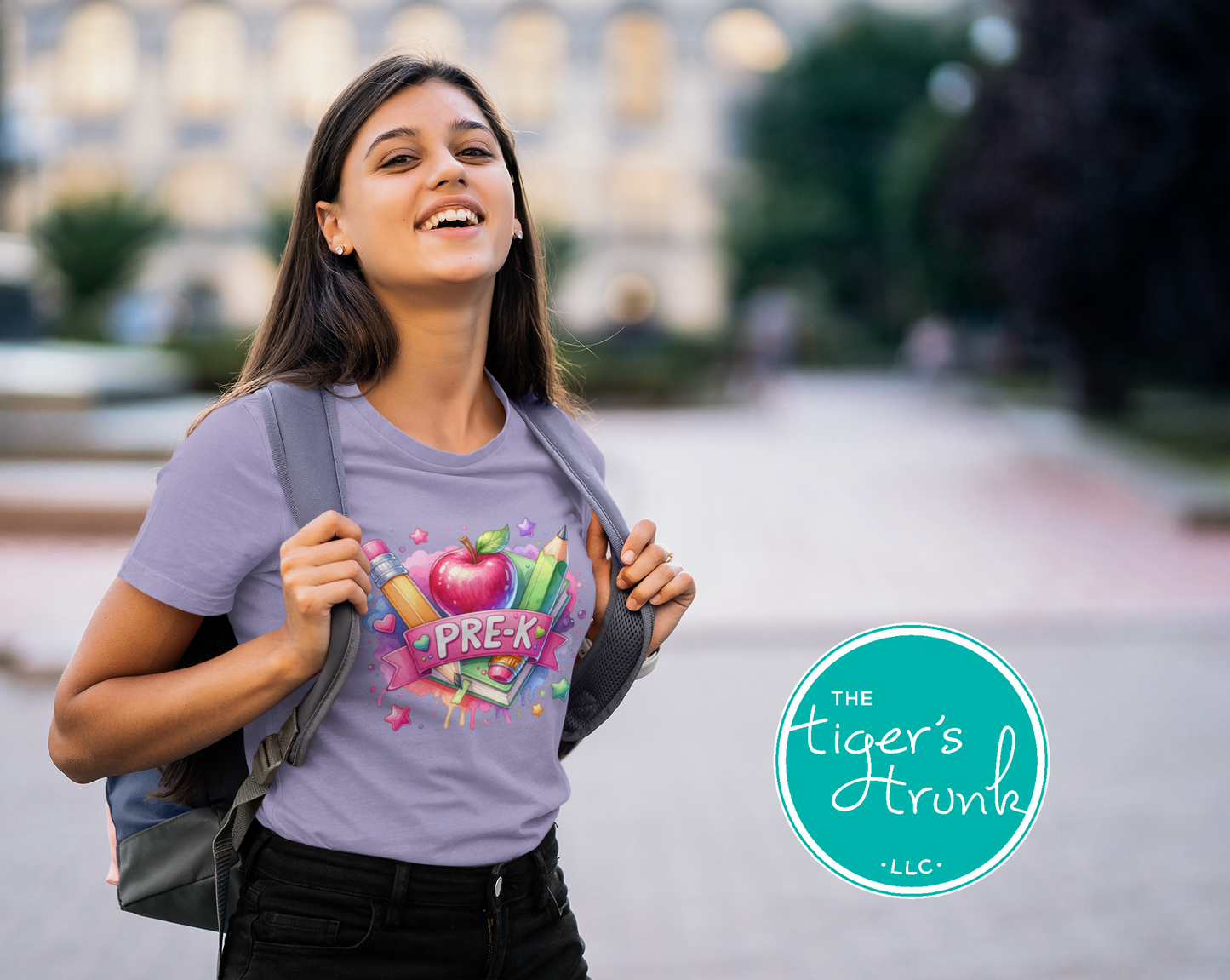 Woman wearing a purple t-shirt with educational graphics and text, standing outdoors with 'The Tiger's Trunk' logo.