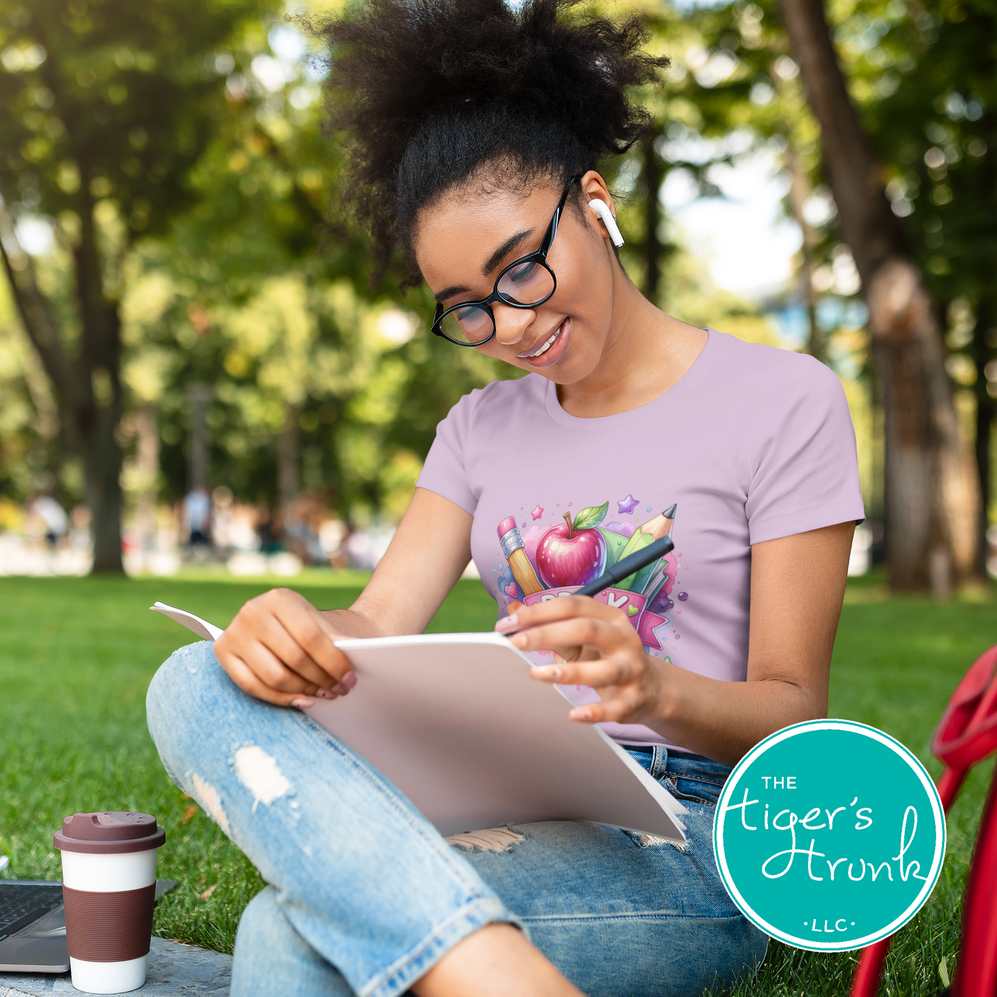 Young girl sitting outdoors, reading a book, with 'The Tiger's Den' logo in the corner.
