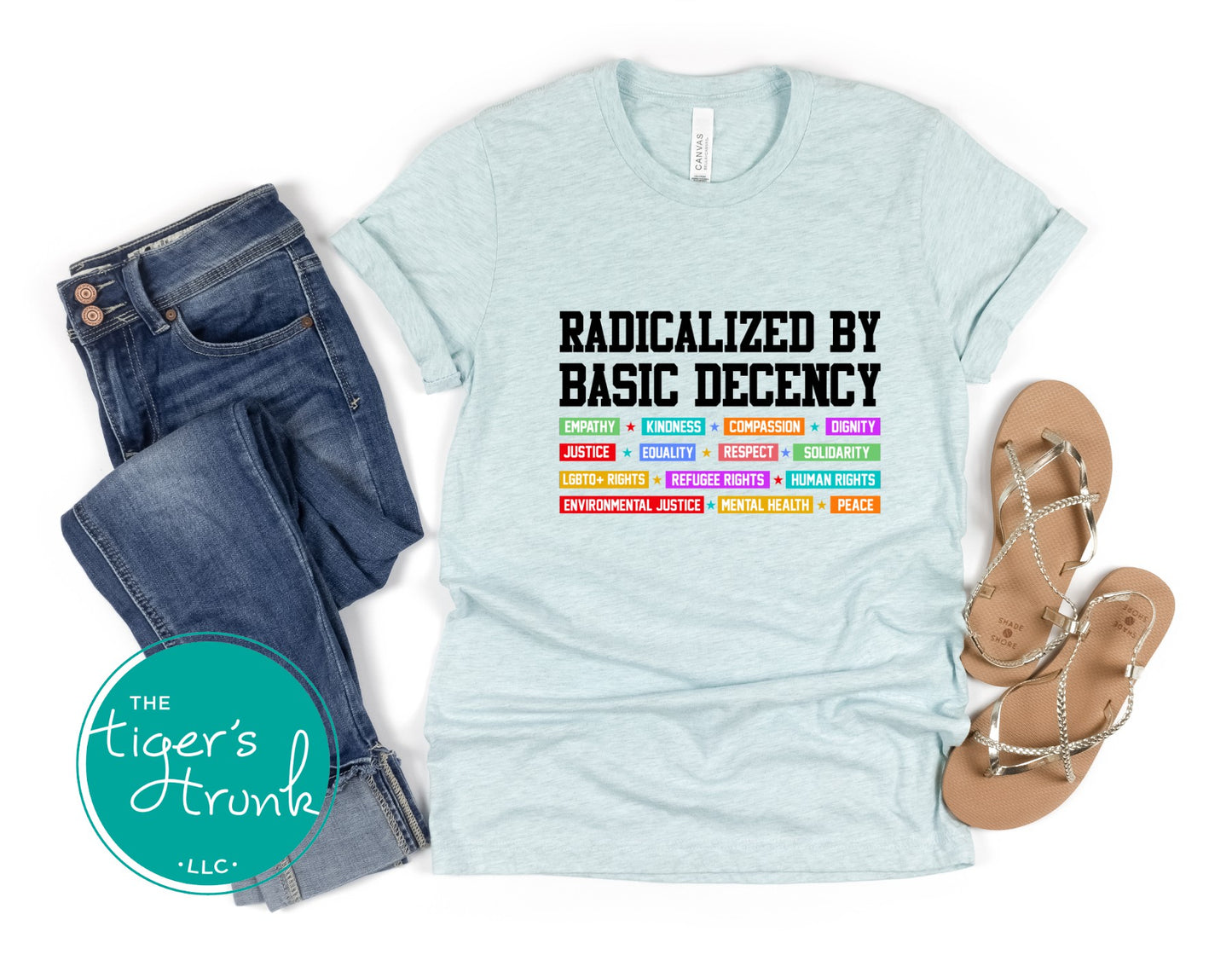 Light blue t-shirt with text, jeans, and sandals on a white background